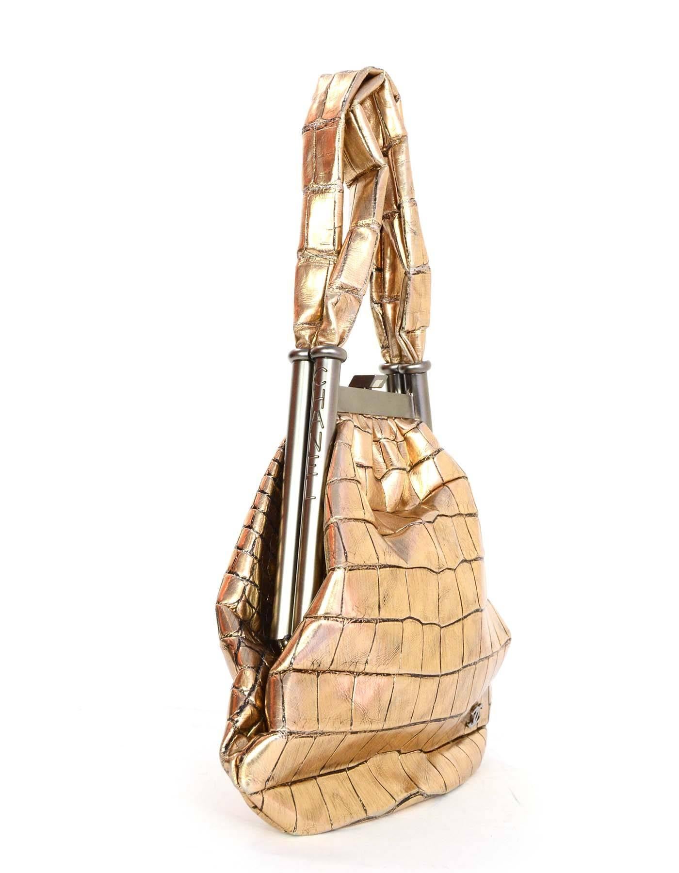 Chanel Metallic Gold Crocodile Frame Bag 
Features small ruthenium CC charm at bottom corner of front panel of bag
Made In: France
Year of Production: 2006-2008
Color: Metallic distressed gold
Hardware: Matte slvertone and ruthenium
Materials: