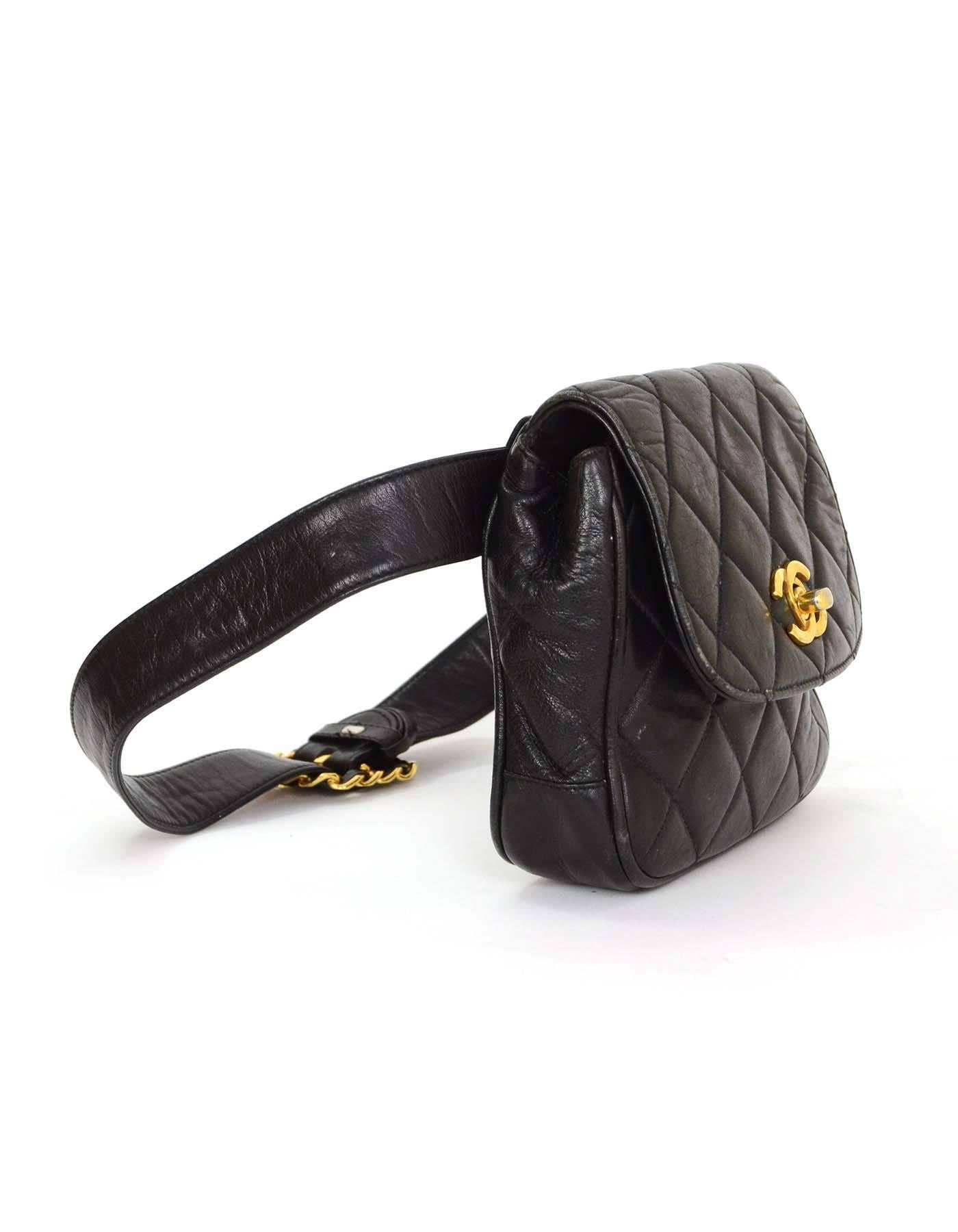 Chanel Black Quilted Belt Bag 
Features black leather woven goldtone chain link belt buckle
Made In: Italy
Year of Production: 1991-1994
Color: Black
Hardware: Goldtone
Materials: Leather
Lining: Black leather
Closure/Opening: Bag- flap top