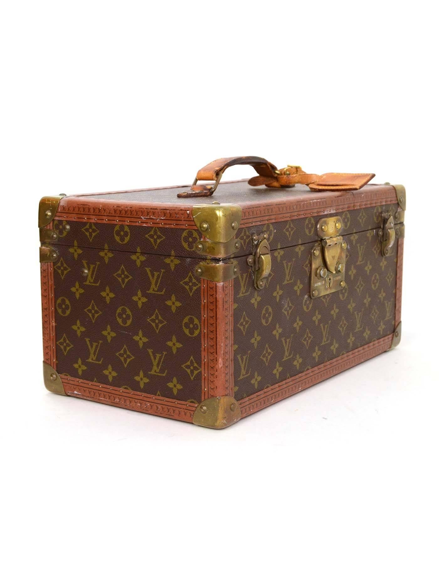 Louis Vuitton Monogram Beauty/Travel Case 
Made In: France
Color: Tan and brown
Hardware: Brass
Materials: Coated canvas, leather, and metal
Lining: Nude coated canvas
Closure/Opening: S-lock closure with two trunk latches
Exterior Pockets: