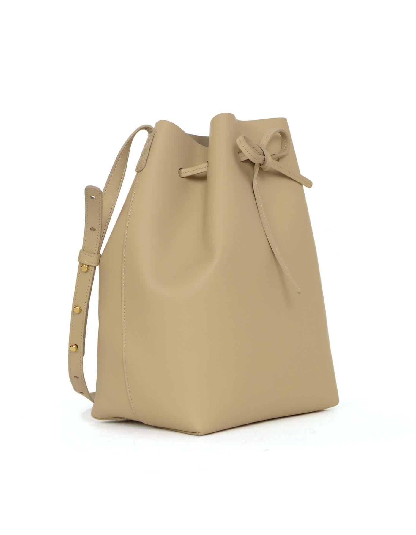 Mansur Gavriel Nude Large Drawstring Bucket Bag 
Features adjustable shoulder strap and removable insert pouch
Made In: Italy
Color: Nude
Hardware: Goldtone
Materials: Leather
Lining: Nude leather
Closure/Opening: Drawstring closure
Exterior