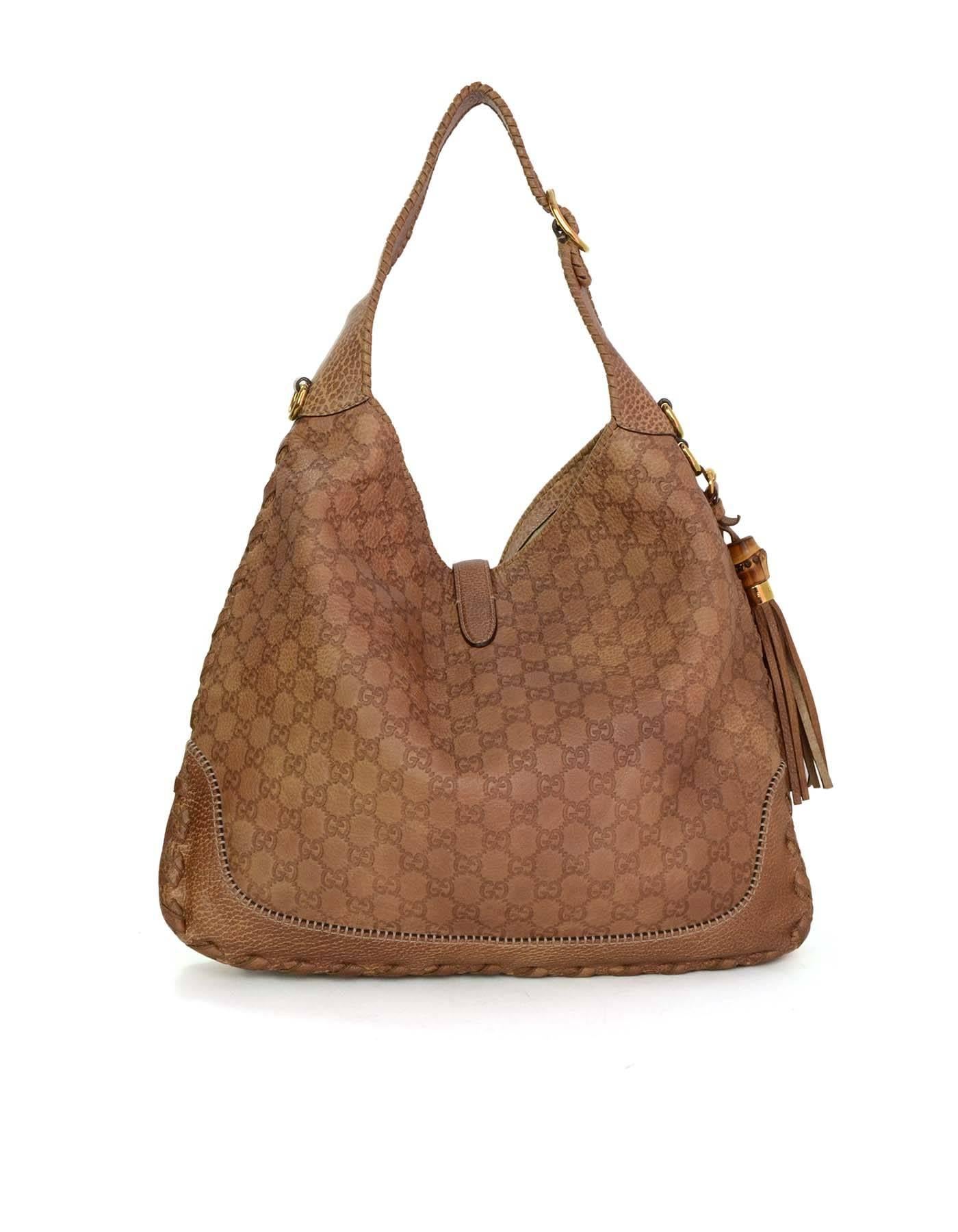 Gucci Tan Gucissima Large New Jackie Shoulder Bag 
Features optional longer crossbody strap and bamboo details at hardware
Made In: Italy
Color: Tan
Hardware: Goldtone
Materials: Leather
Lining: Beige canvas
Closure/Opening: Open top with