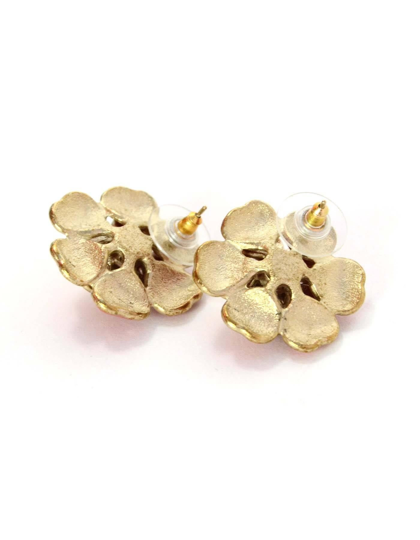 Chanel Pink Enamel Camelia Earrings  
Features crystal clusters in center of flowers and small CC pendants
Color: Pink and goldtone
Materials: Metal, enamel and crystal
Closure: Pierced back
Overall Condition: Excellent pre-owned