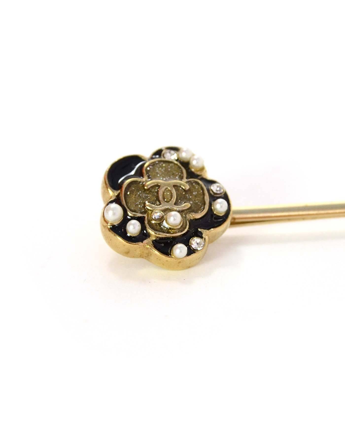 Chanel Gold & Black Camelia Flower Hair Pin 
Features small CC in center of Camelia flower with crystals and faux pearls surrounding it
Color: Goldtone, black, and ivory
Materials: Metal, enamel, crystal and faux pearl
Closure: None
Overall