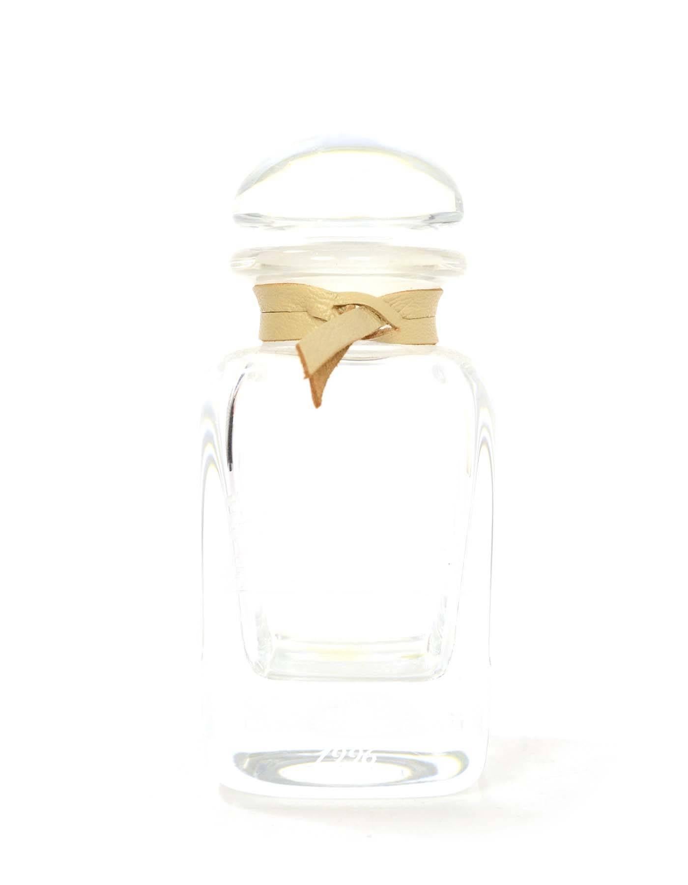 Hermes Ltd Ed. Glass Eau D'Hermes 1996 Perfume Bottle 
Features tan leather cord wrapped around neck of bottle
Holds 4 FL OZ
Made In: France
Year of Production: 1996
Color: Clear
Materials: Glass
Closure: Glass bottle top
Stamp: Eau De