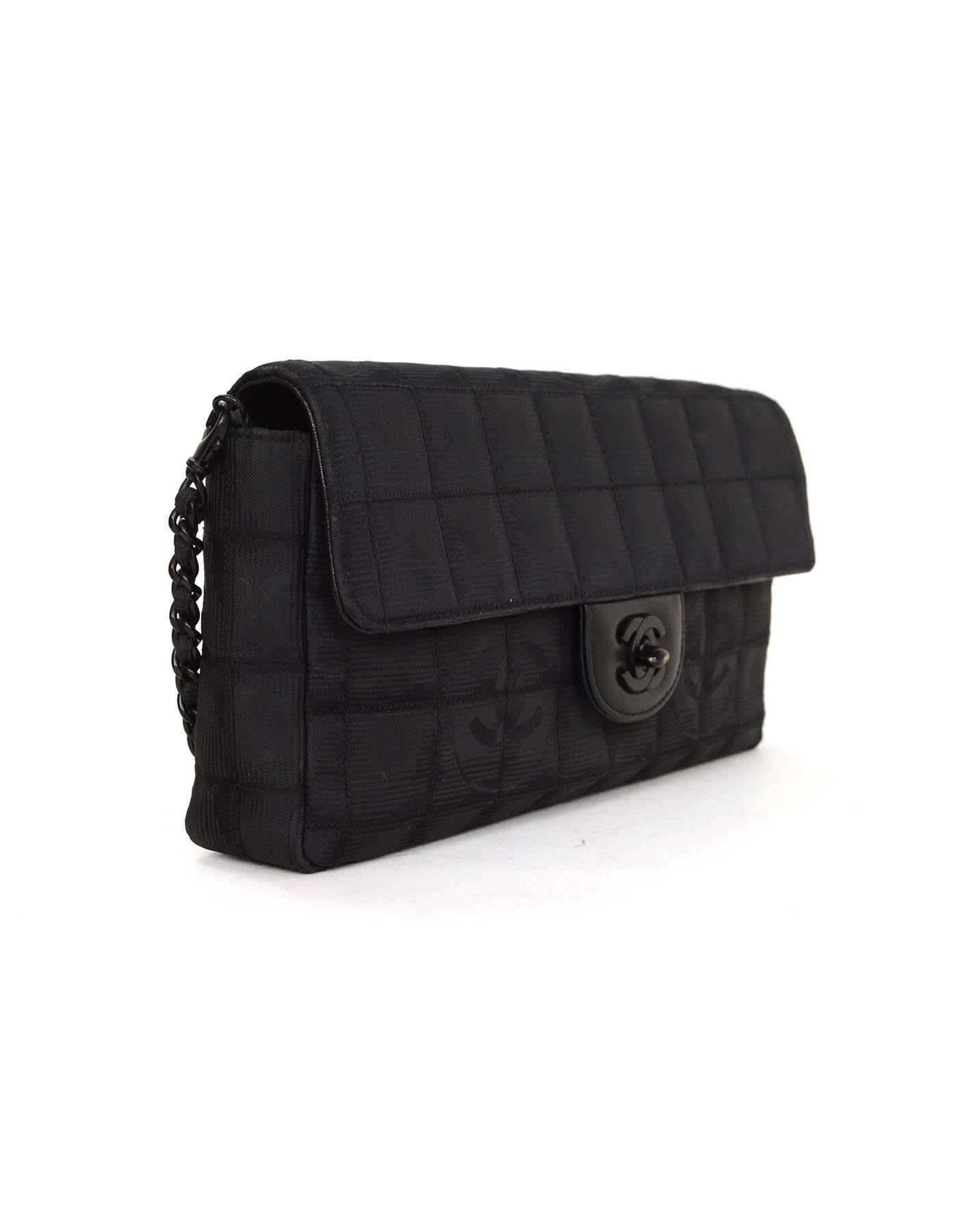 Chanel Canvas Travel Ligne East/West Flap Bag 
Features removable shoulder strap
Made In: France
Year of Production: 2000-2002
Color: Black
Hardware: Black
Materials: Canvas and leather
Lining: Black leather and satin
Closure/Opening: Flap