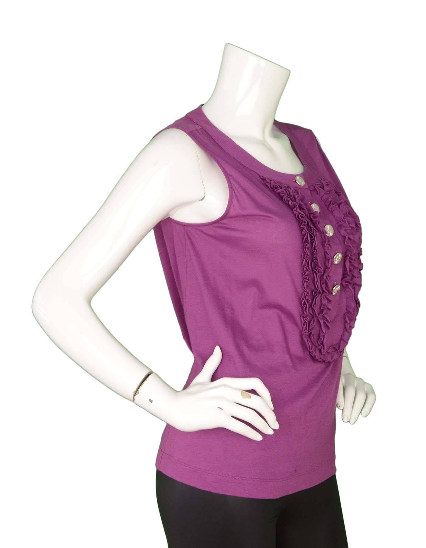 Chanel Purple Cotton Sleeveless Top
Features ruffles down front center with silvertone CC decorative buttons
Made In: France
Year of Production: 2009
Color: Purple
Composition: 100% cotton
Lining: None
Closure/Opening: Pull over with buttons