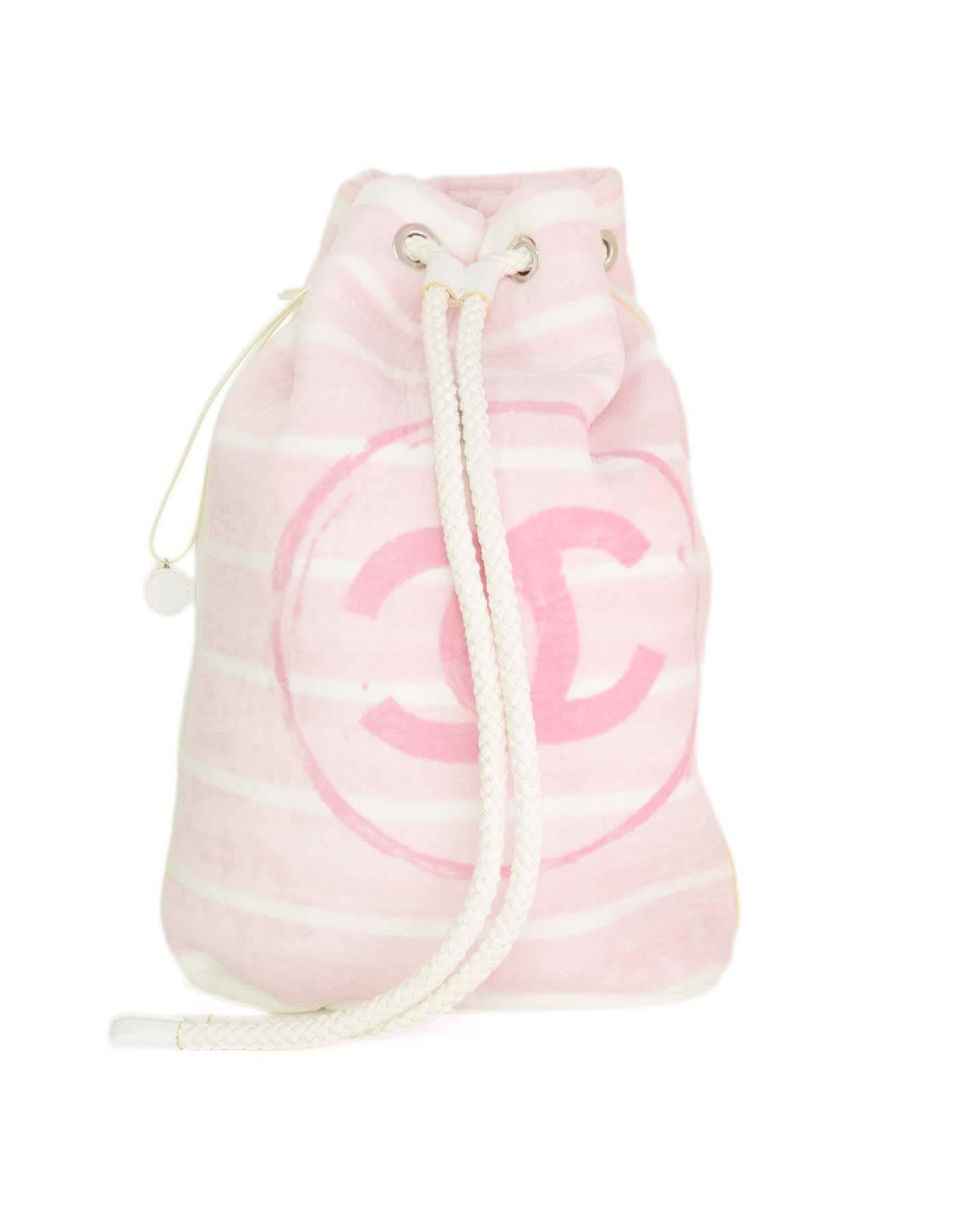 Chanel Pink & White Terrycloth Bag & Beach Towel Set 
Both bag and towel feature white stripes with large pink CC printed in center
Made In: Italy
Year of Production: 2011
Color: White and pink
Hardware: Bag- silvertone
Materials: