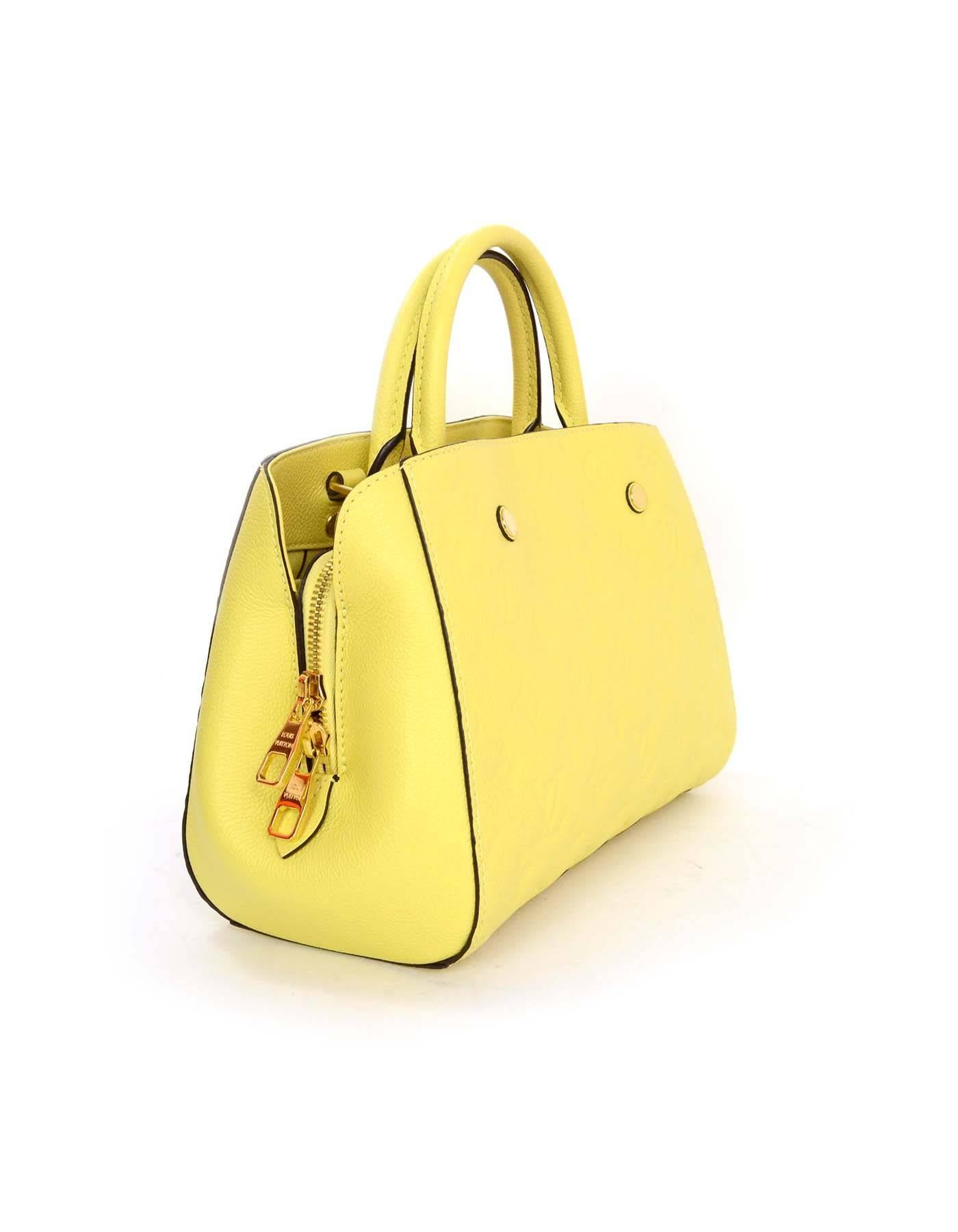 Louis Vuitton Yellow Monogram Empreinte Leather Montaigne BB Bag
Features optional shoulder/crossbody strap

Made In: France
Year of Production: 2014
Color: Citrine yellow
Hardware: Goldtone
Materials: Empreinte leather
Lining: Yellow with