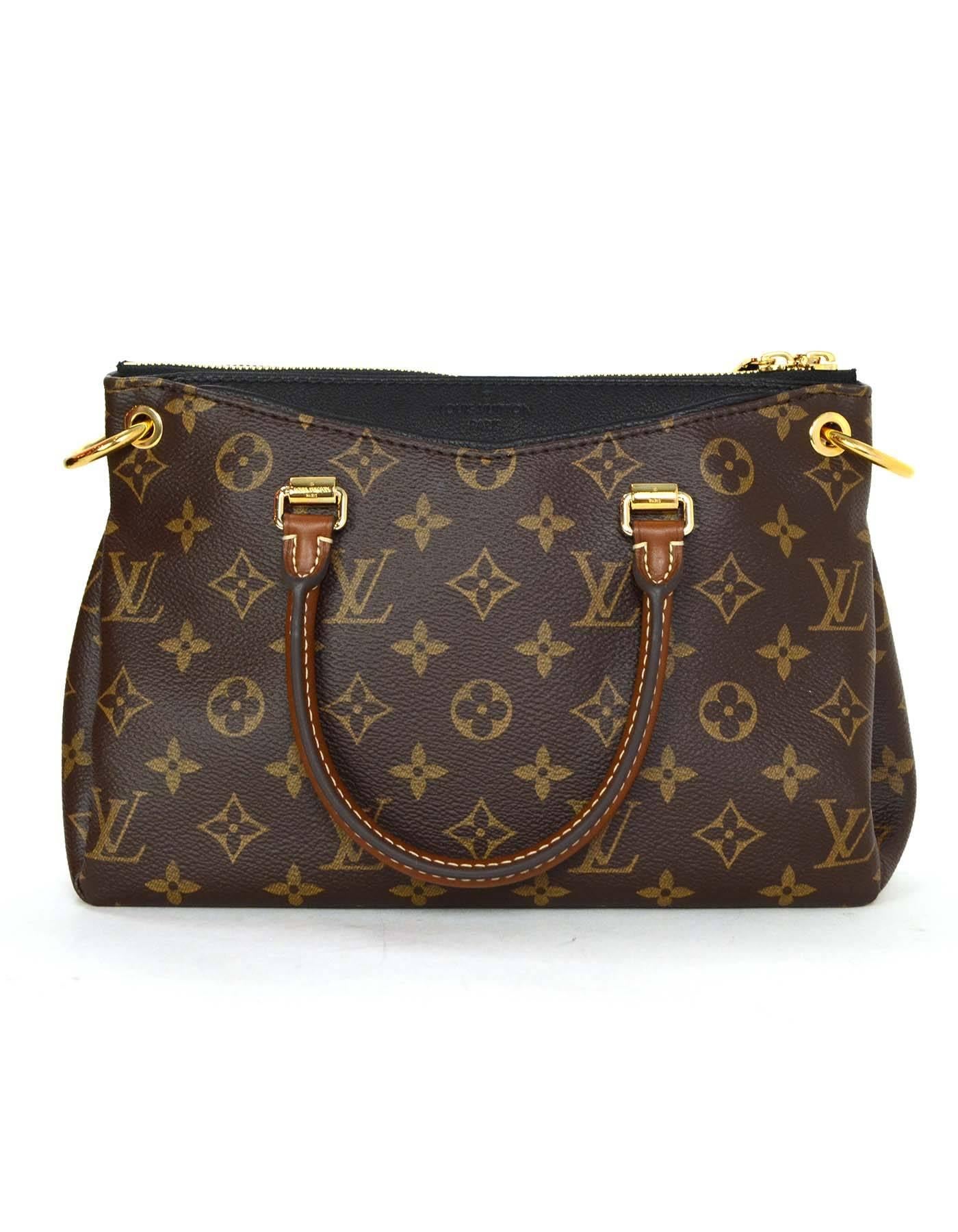 Louis Vuitton Monogram Canvas & Black Leather Pallas BB Bag
Features optional shoulder/crossbody strap

Made In: U.S.A
Year of Production: 2014
Color: Brown and black
Hardware: Goldtone
Materials: Coated canvas and leather
Lining: Black