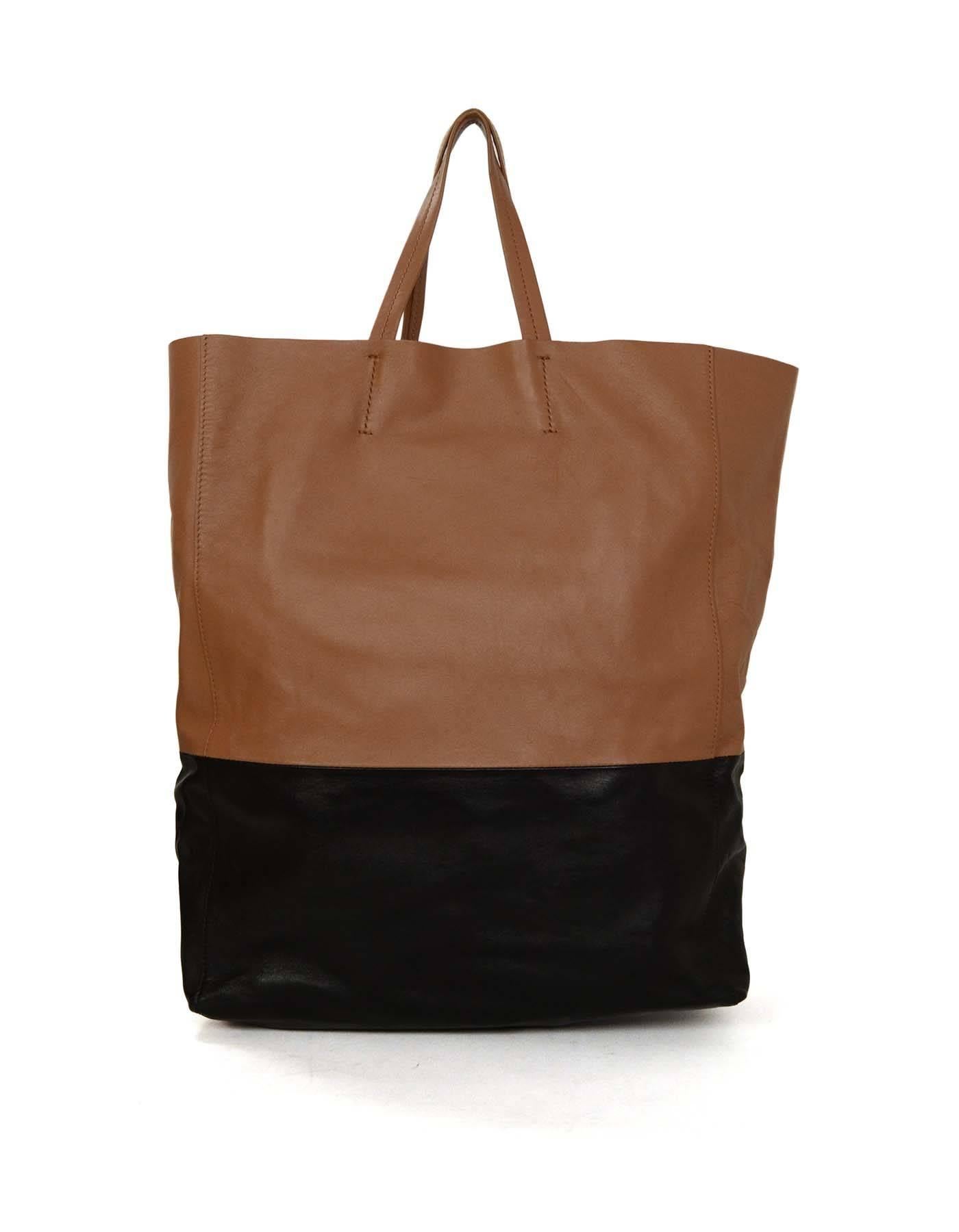 Celine Black & Tan Leather Cabas Tote

Made in: Italy
Color: Black and tan
Hardware: None
Materials: Leather
Lining: Tan suede
Closure/opening: Open top
Exterior Pockets: None
Interior Pockets: One internal pocket with zipper
Serial