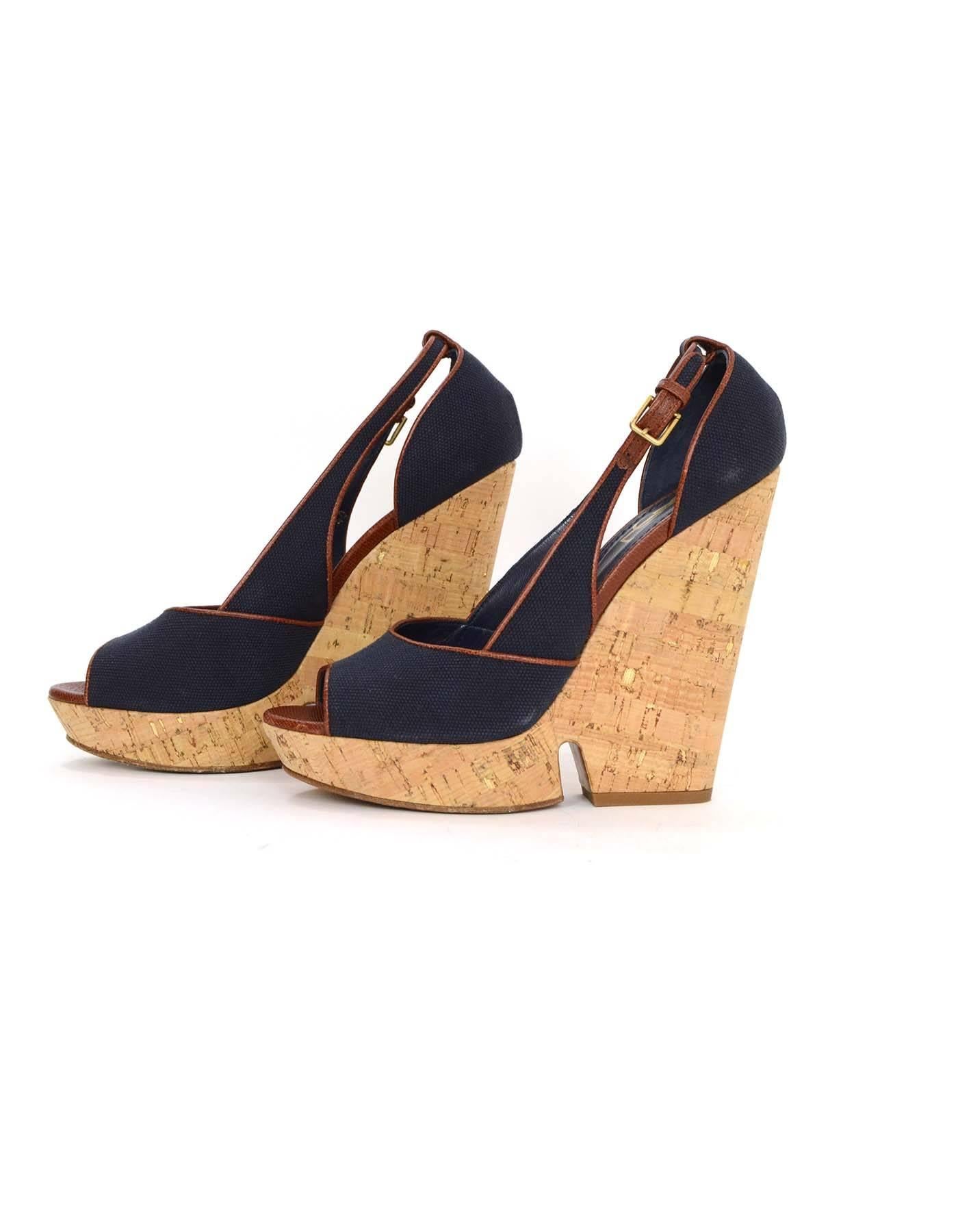 Yves Saint Laurent Navy Canvas Deauville Cork Wedges 
Features brown leather piping and trim throughout
Made In: Italy
Color: Navy and brown
Materials: Canvas, leather and cork
Closure/Opening: Outter ankle buckle strap
Sole Stamp: Yves Saint