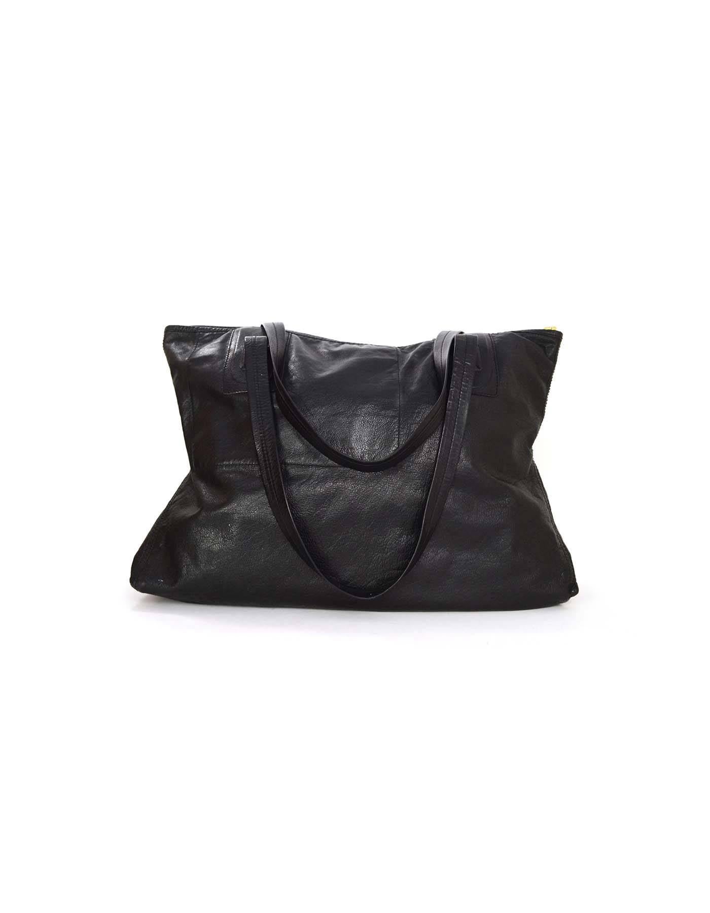 Rick Owens Black Distressed Leather Tote 
Made In: Italy
Color: Black
Hardware: Goldtone
Materials: Distressed leather
Lining: Black suede
Closure/Opening: Zip across top
Exterior Pockets: None
Interior Pockets: One zipper pocket
Serial