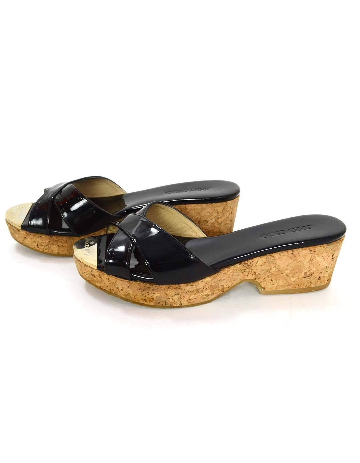 Jimmy Choo Black Patent & Cork Platform Mules 
Features goldtone cap at insole with Jimmy Choo engraved in it
Made In: Spain
Color: Black and tan
Materials: Patent leather, cork and metal
Closure/Opening: Slide on
Sole Stamp: Jimmy Choo Made