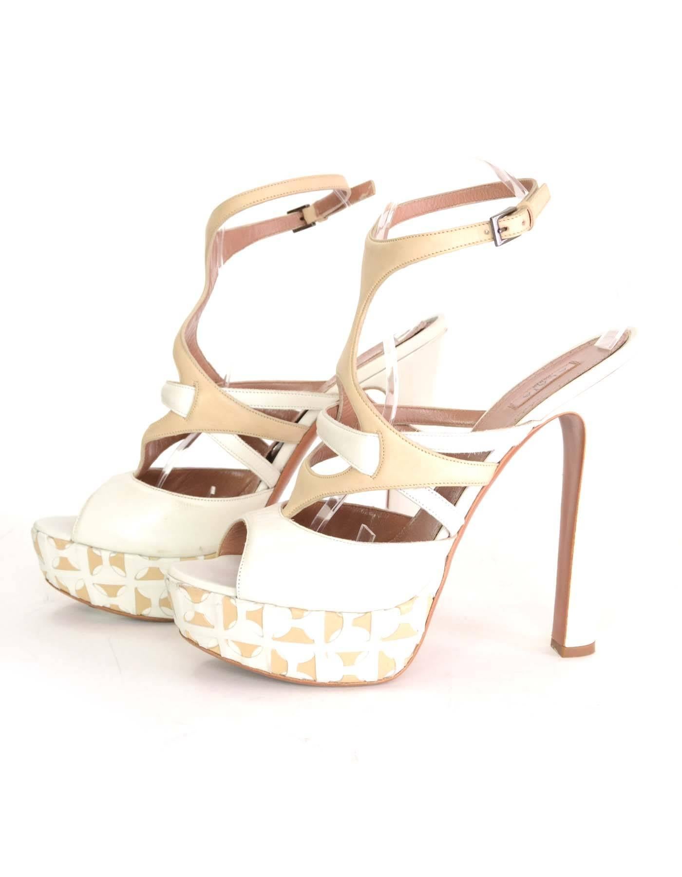 Alaia White & Beige Leather Platform Sandals 
Features beige and white leather cut out designs on platform
Made In: Italy
Color: Beige and white
Materials: Leather
Closure/Opening: Ankle strap with buckle and notch closure
Sole Stamp: