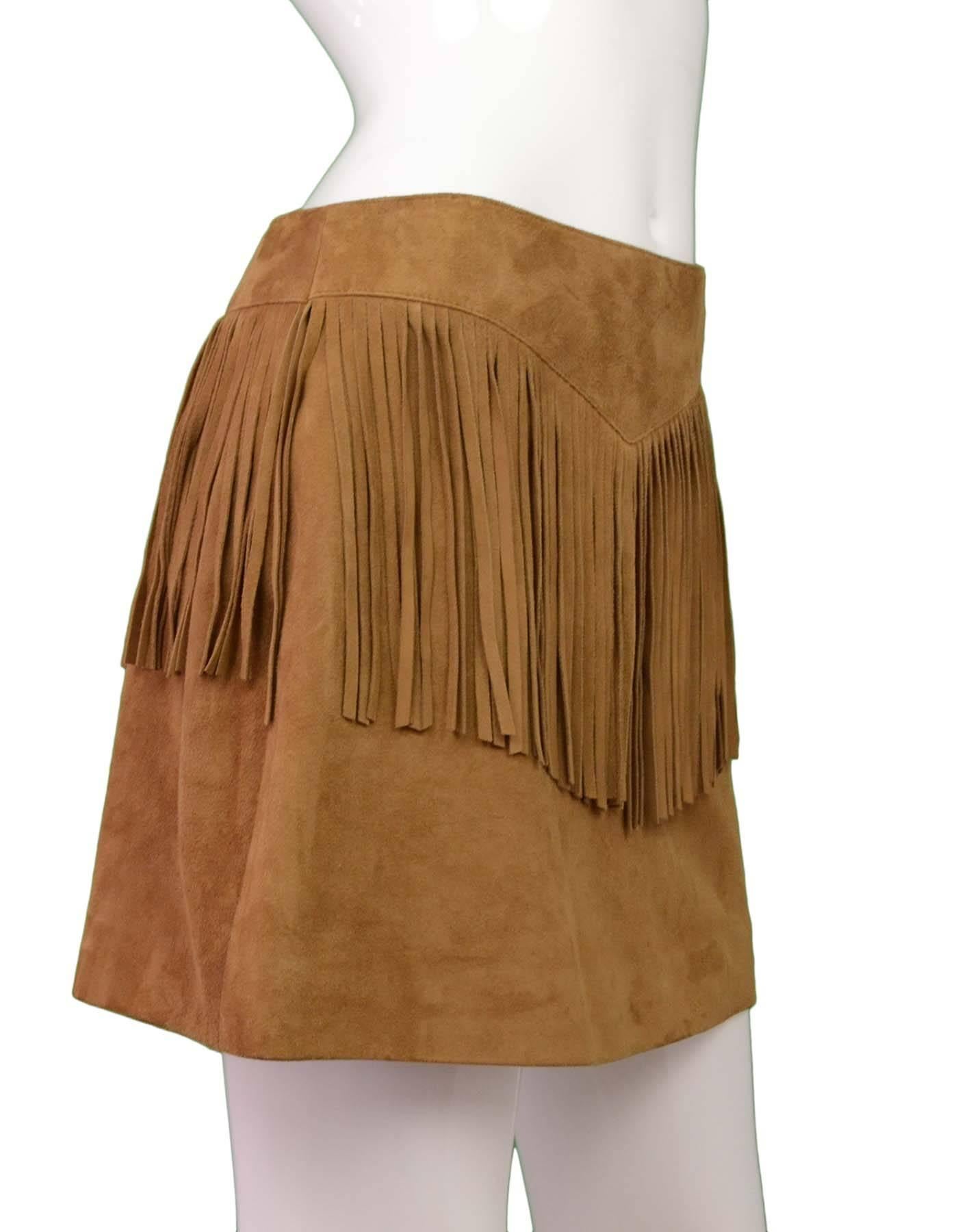 Saint Laurent Tan Suede Fringe Mini Skirt 
Made In: Italy
Color: Tan
Composition: 100% goat skin
Lining: Black, 100% silk
Closure/Opening: Waist zipper
Exterior Pockets: None
Interior Pockets: None
Retail Price: $2,350 + tax
Overall