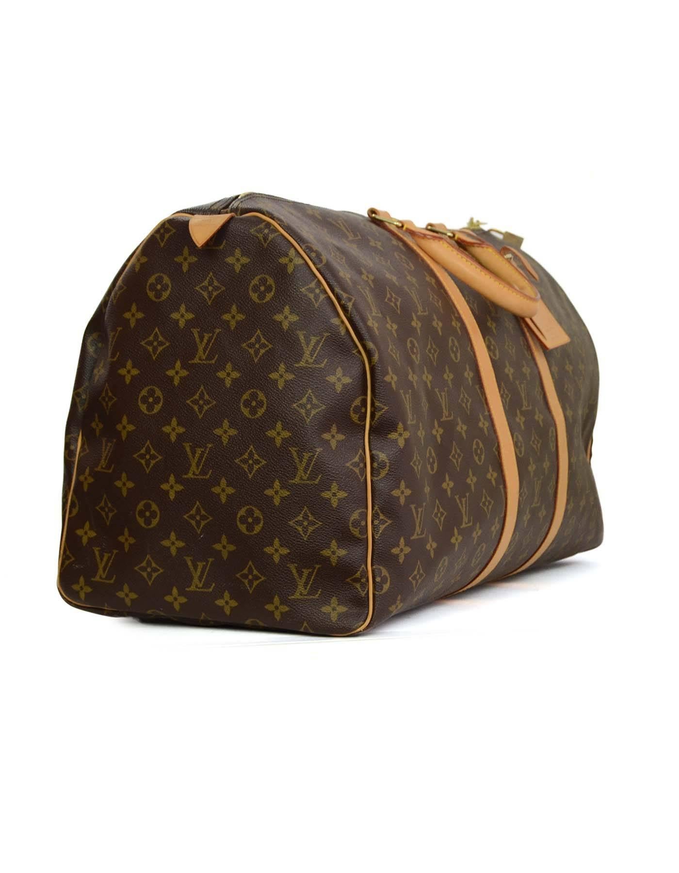 Louis Vuitton Monogram Keepall 55 Luggage
Features leather trim throughout
Made In: USA
Year of Production: 2005
Color: Brown and tan
Hardware: Goldtone
Materials: Coated canvas and leather
Lining: Brown canvas
Closure/Opening: Double zip