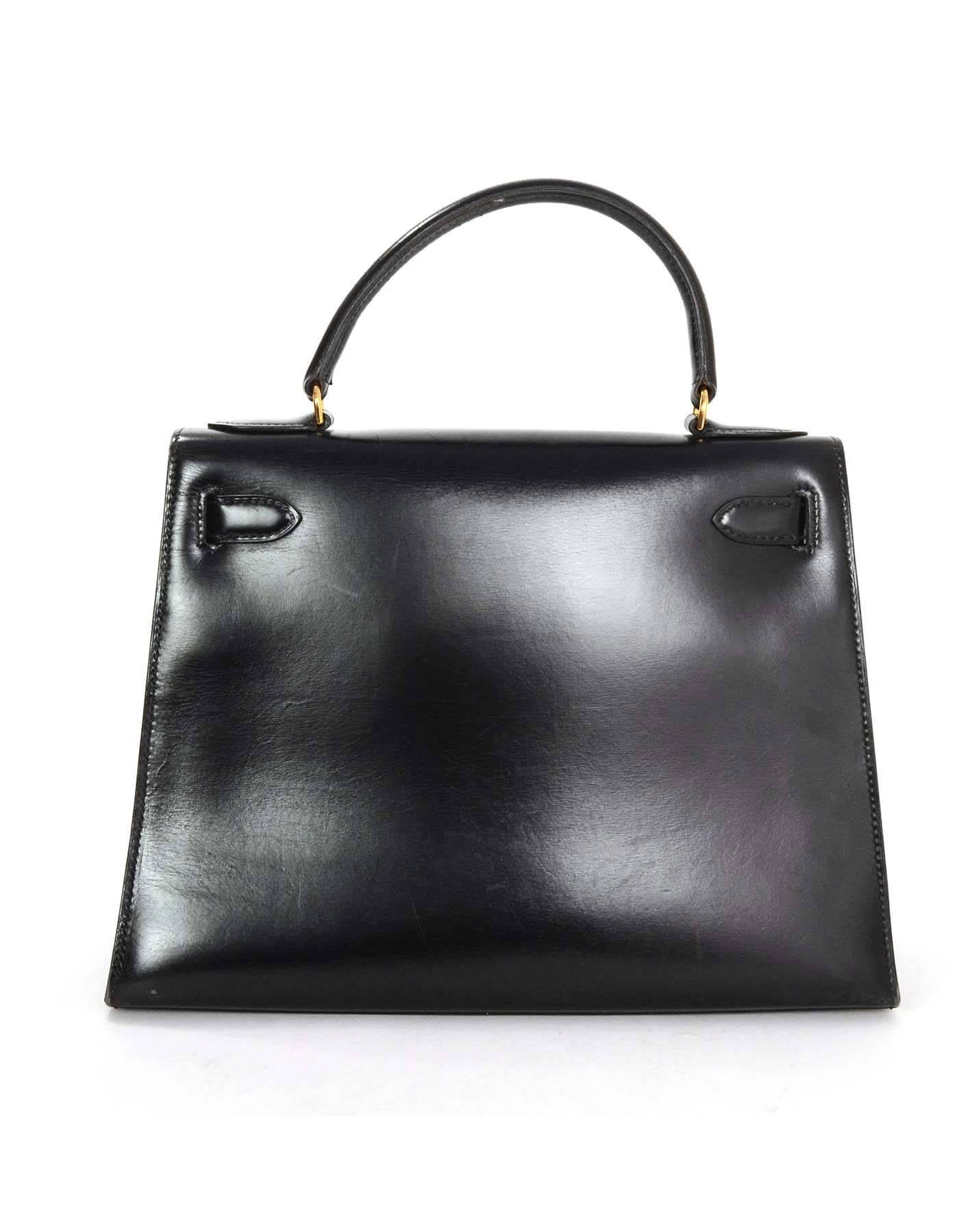 Hermes Black Box Rigid Sellier 28cm Kelly Bag
Features non-Hermes removable shoulder/crossbody strap
Made in: France
Year of Production: 1981
Color: Black
Hardware: Goldtone
Materials: Box leather
Lining: Black chevre
