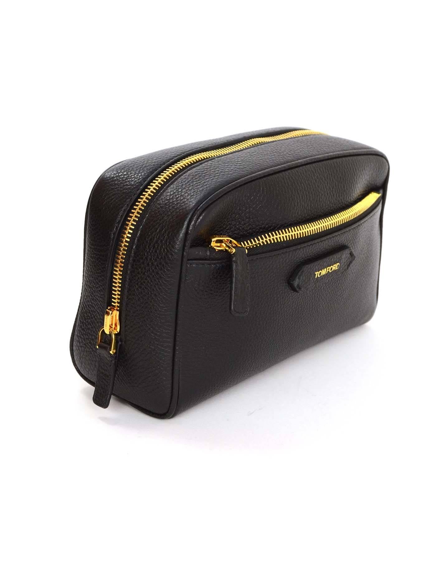Tom Ford Black Leather Toiletry Bag 
Features leather tab on front with Tom Ford logo in goldtone
Made In: Italy
Color: Black
Hardware: Goldtone
Materials: Leather
Lining: Black grosgrain
Closure/Opening: Zip across top
Exterior Pockets: One