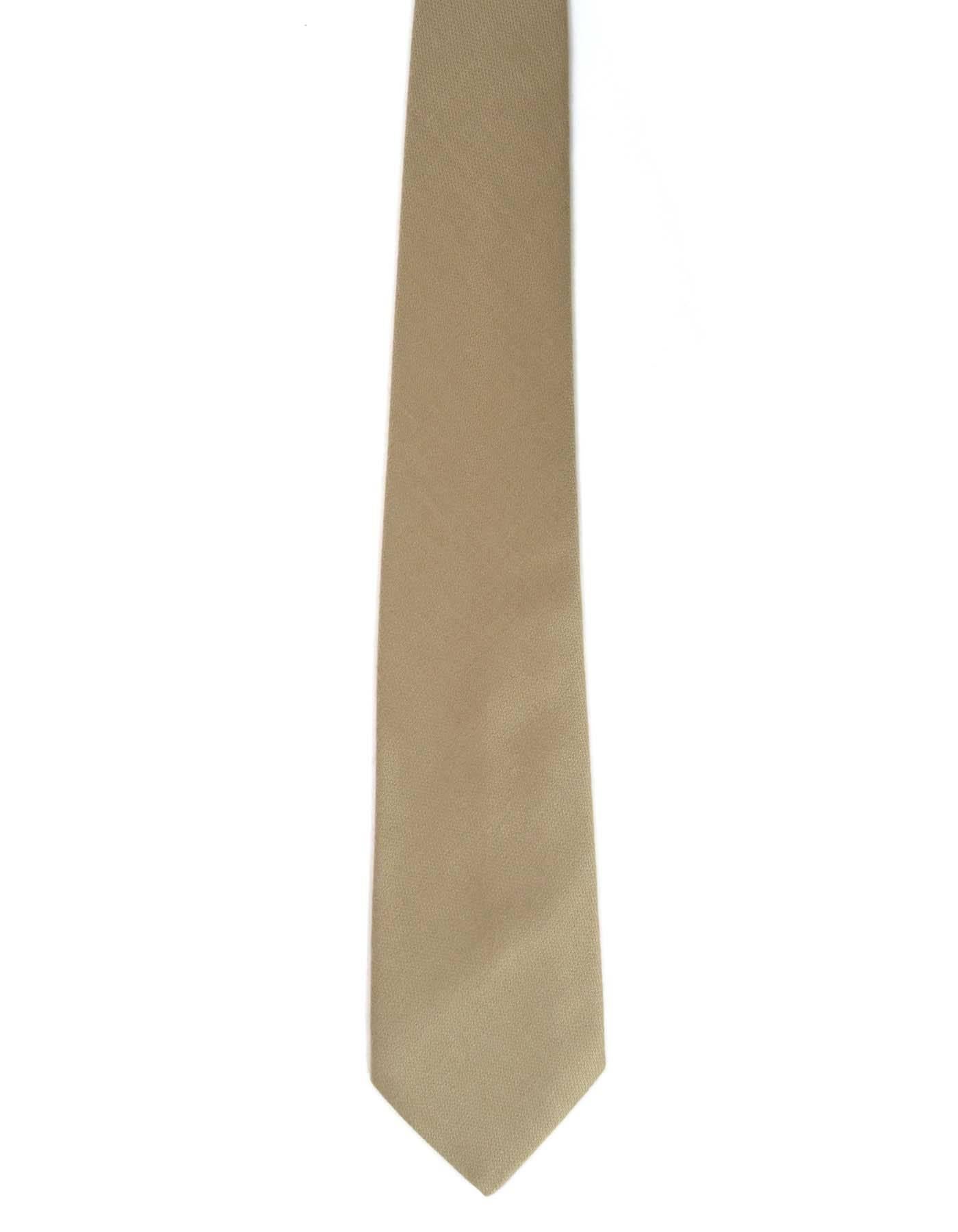 Hermes Tan Silk Tie
Made In: France
Color: Tan
Composition: 100% silk
Overall Condition: Excellent pre-owned condition with the exception of some minor pilling throughout
Measurements: 
Length: 56"
Width: 3.5"
