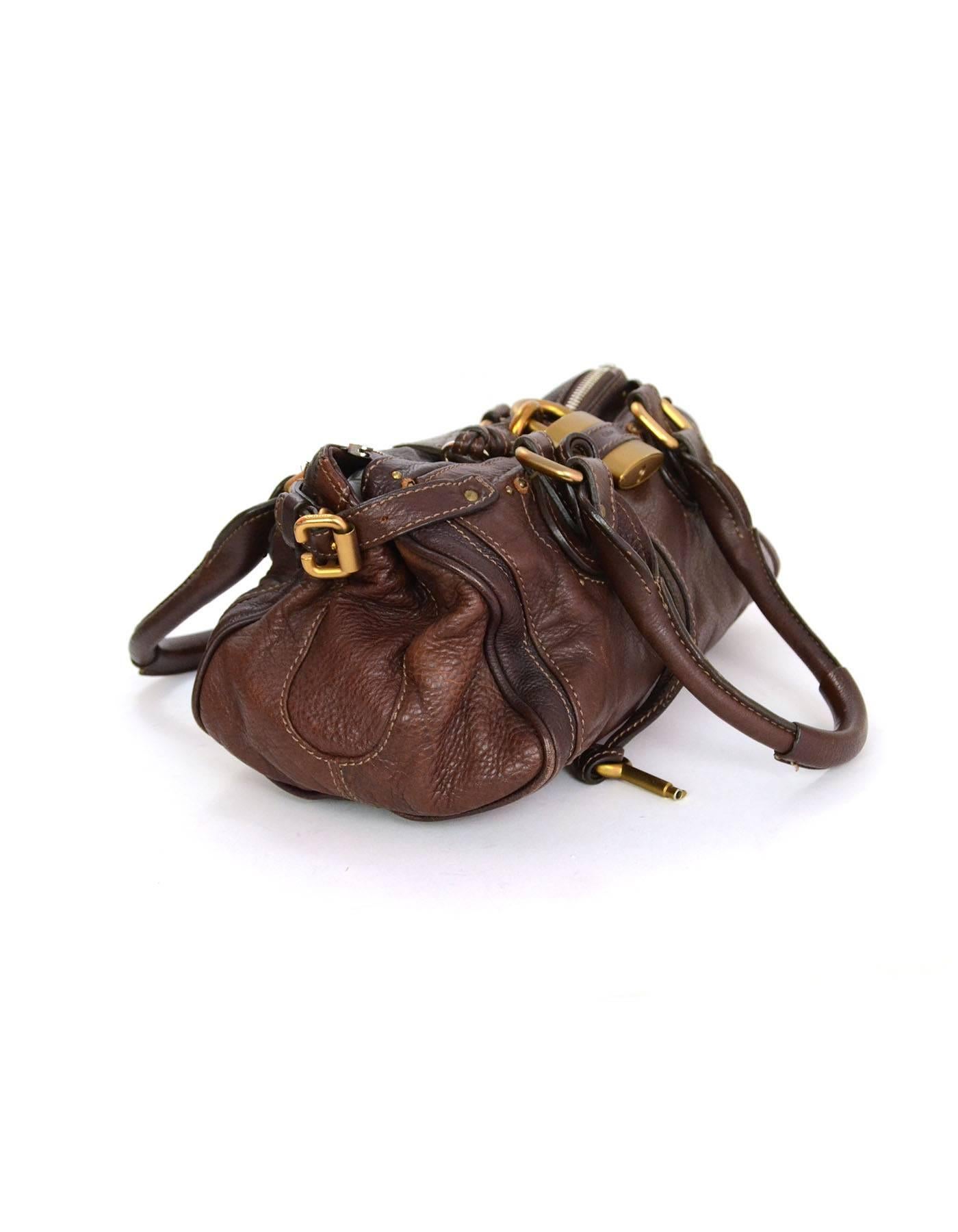Chloe Brown Leather Paddington Bag
Features oversized Chloe padlock 
Made In: Italy
Color: Dark brown
Hardware: Goldtone and silvertone
Materials: Leather
Lining: Brown canvas
Closure/Opening: Dual sided zipper closure that meet in middle and