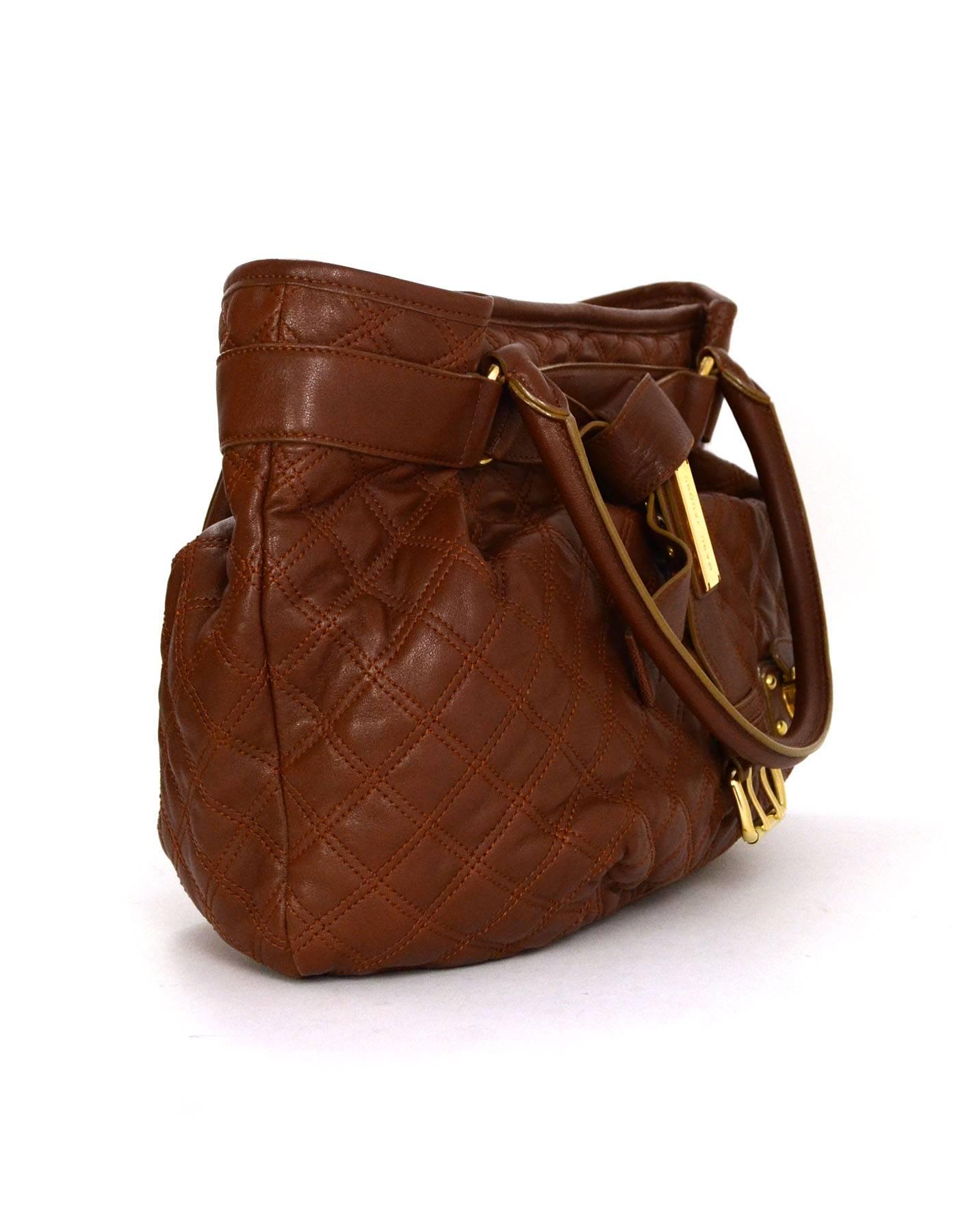 Marc Jacobs Brown Quilted Leather Linda Tote
Features knotted leather sash/strap around top of bag with Marc Jacobs name place
Made In: Italy
Color: Brown
Hardware: Goldtone
Materials: Leather 
Lining: Grey textile
Closure/Opening: Zip across