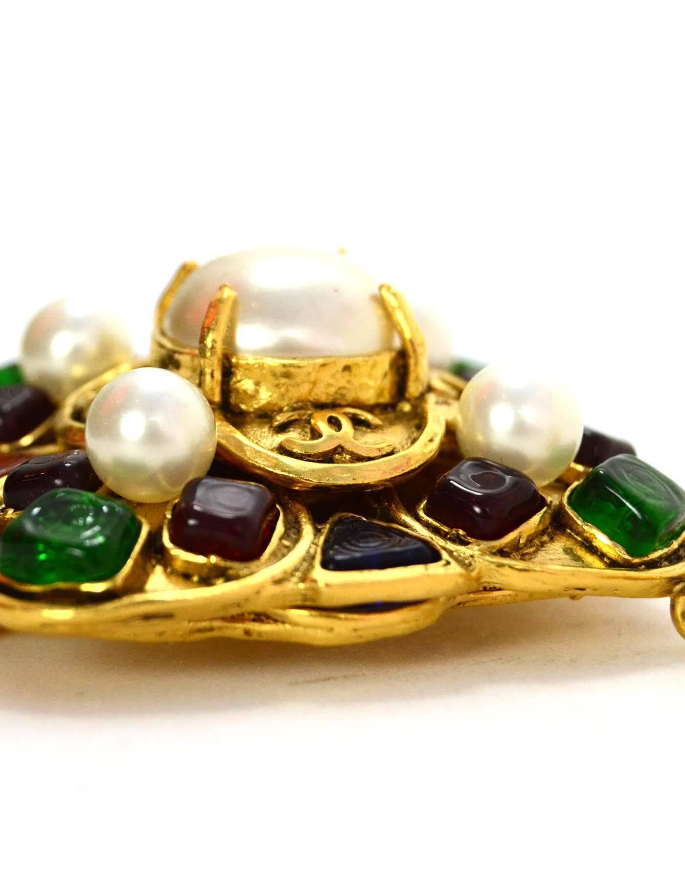 Chanel Vintage '94 Multi-Color Gripoix & Pearl Drop Brooch
Features pendant with green, red, blue and amber gripoix with faux pearl accents. CC detailing around center pearl

-Made In: France
-Year of Production: 1994
-Color: Goldtone, red,