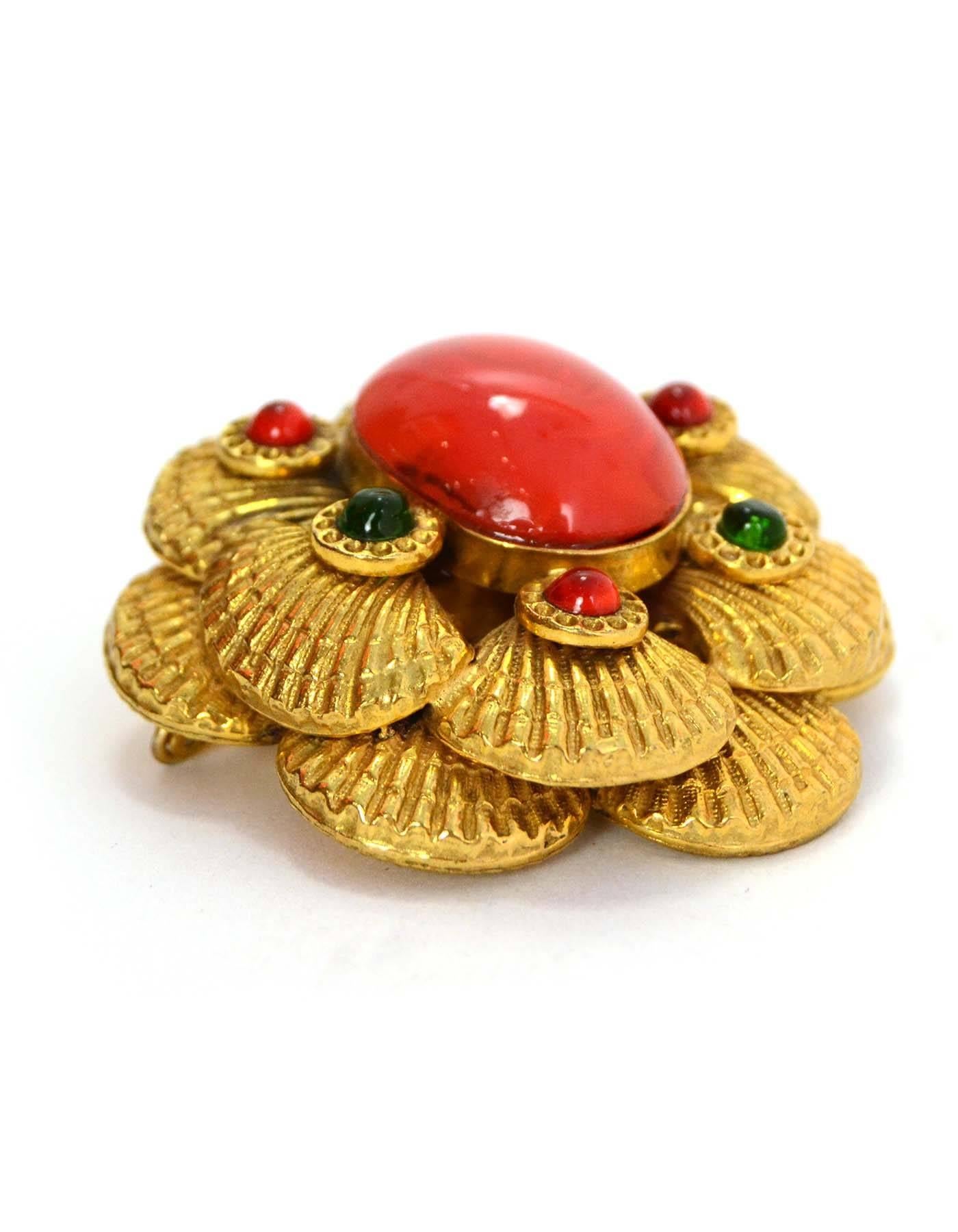 Chanel Goldtone Coral Seashell Brooch
Features layered goldtone seashells with center coral colored stone with green and coral accent stones surrounding.  Hook at back allows for brooch to also be worn as a pendant. 

    Made In: France
   