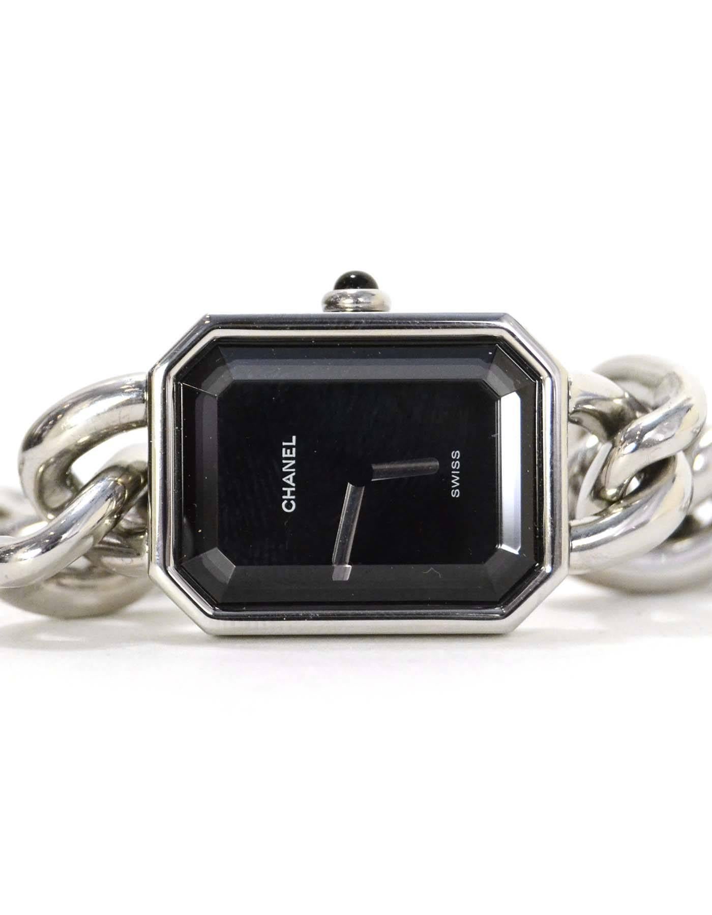 Chanel Vintage '87 Silver Premiere Chain Link Watch
Features black face.  30 meters water resistant

Made In: Switzerland
Year of Production: 1987
Color: Silvertone with black lacquered dial 
Materials: Stainless steel and glass
Closure: Push