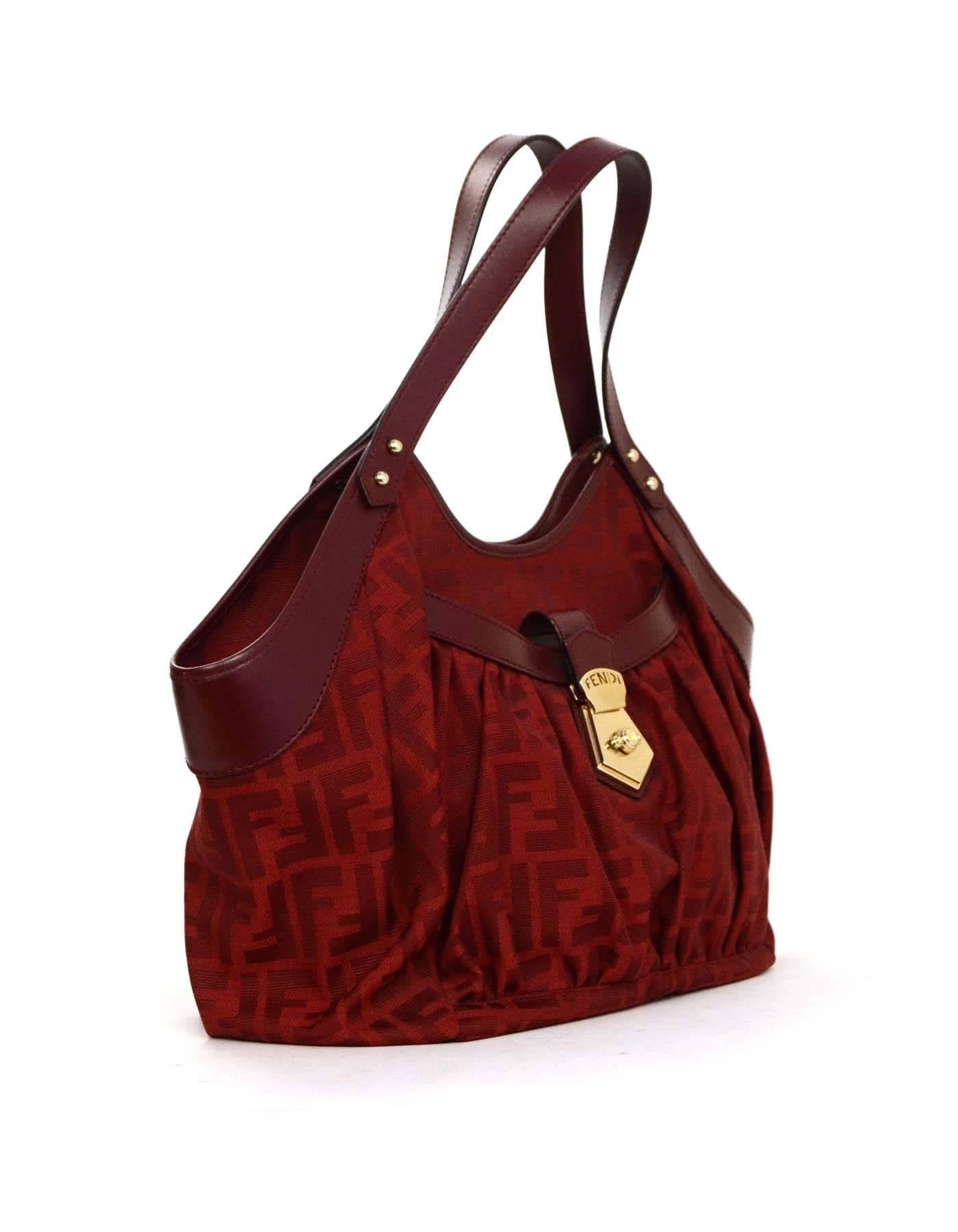 Fendi Red Leather & Zucca Print Canvas Bag 
Features leather strap with goldtone Fendi logo on front pocket
Made In: Italy
Year of Production: 2011
Color: Red
Hardware: Pale goldtone
Materials: Leather and canvas
Lining: Grey