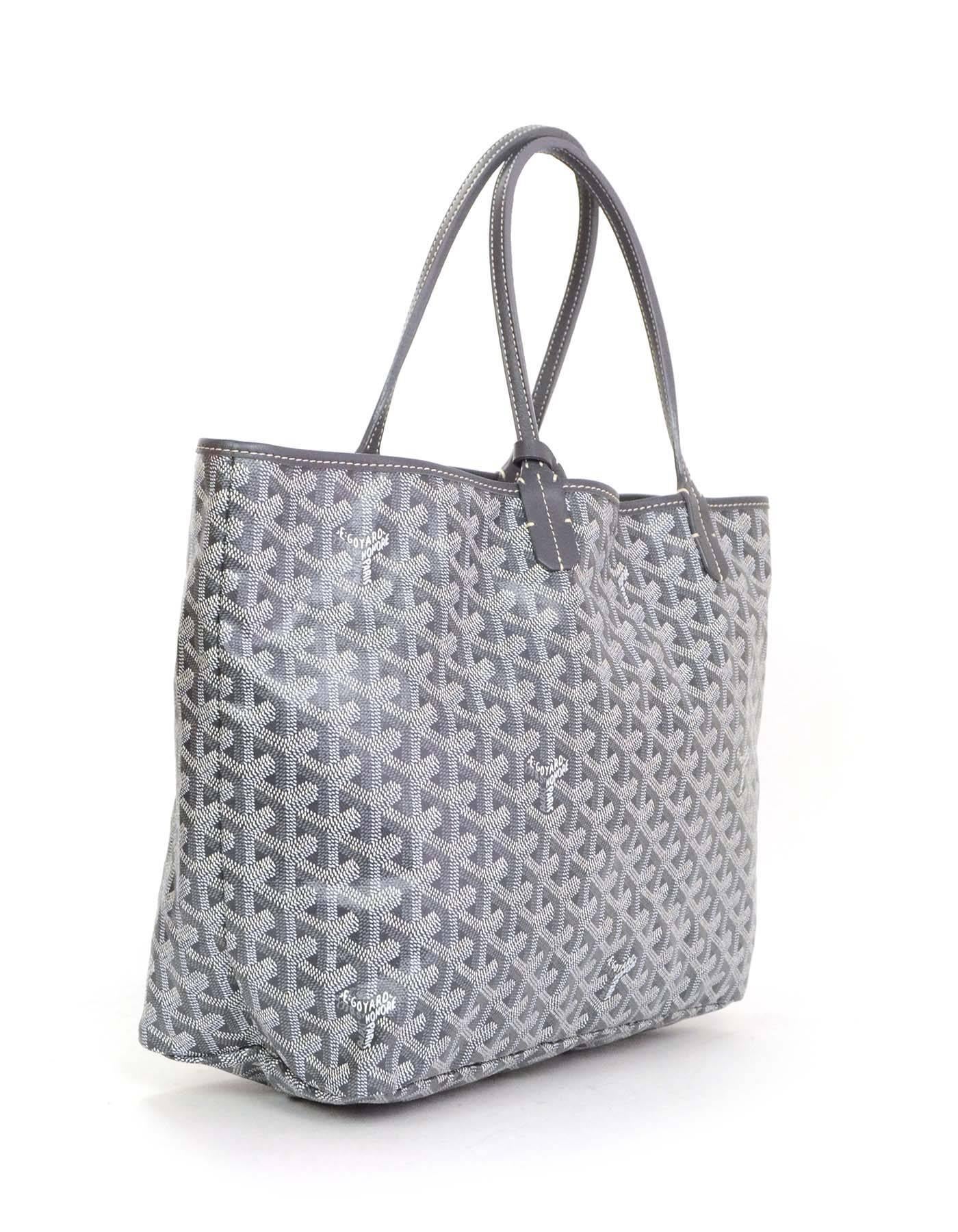 Goyard Grey Chevron Saint Louis PM Tote
Features grey cowhide leather trim

    Made In: France
    Color: Grey and white
    Hardware: Silvertone
    Materials: Coated canvas and leather
    Lining: Beige cotton
    Closure/Opening: Open