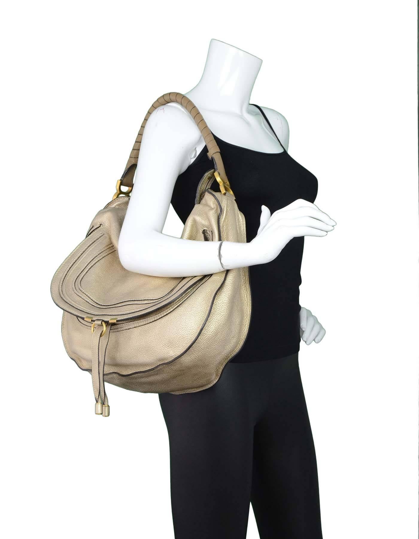 Chloe Gold Leather Large Marcie Hobo with GHW

Features woven handle detail

Made In: Italy
Color: Gold
Hardware: Bushed goldtone
Materials: Leather
Lining: Black textile
Closure/opening: Zip top closure
Exterior Pockets: One pocket at