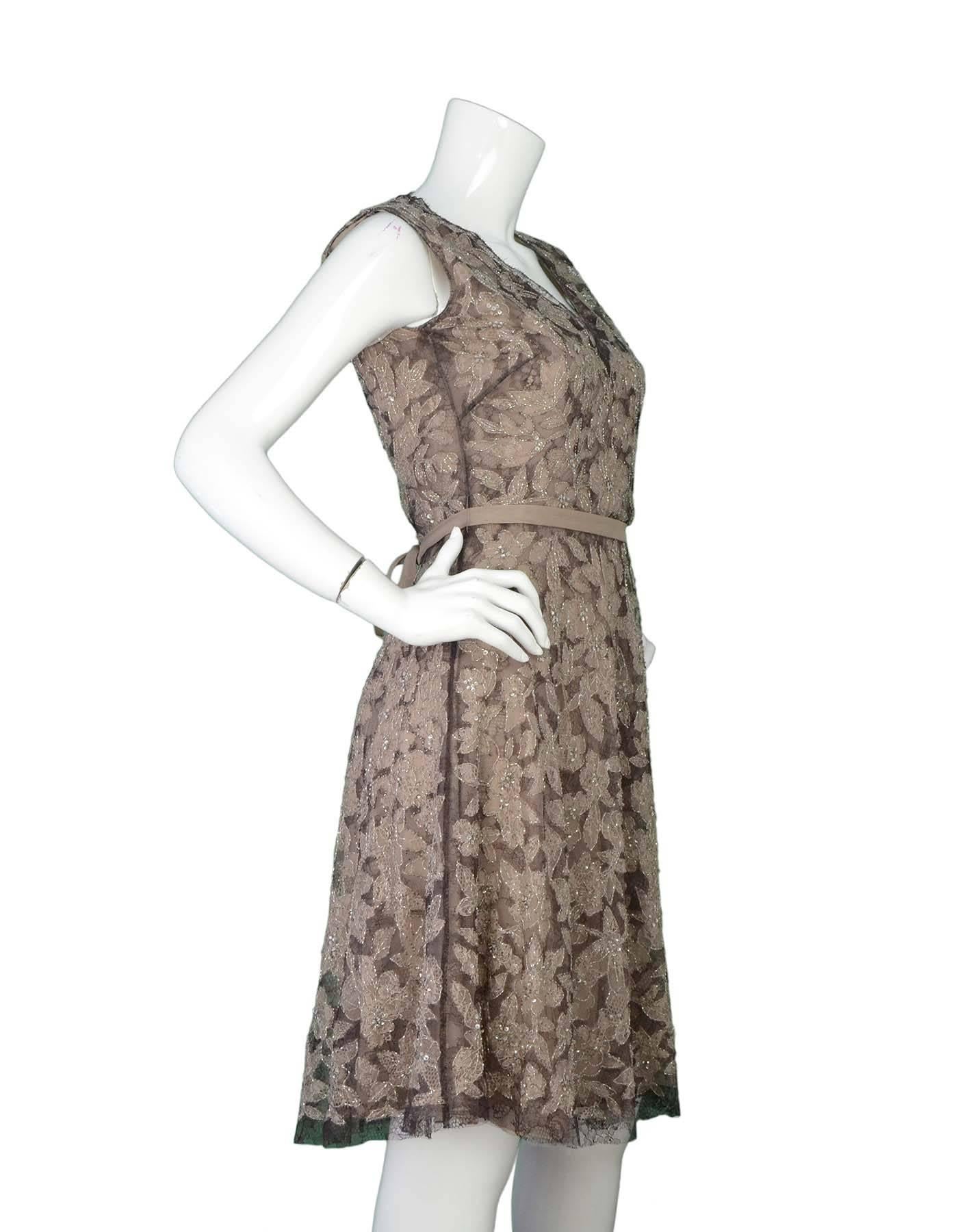 Valentino Beaded Sleeveless Dress sz Small
Features floral lace and beaded detail throughout with tie belt at waist

Made In: Italy
Color: Beige and brown
Lining: Beige lining
Closure/Opening: Zip closure at back
Overall Condition: Excellent