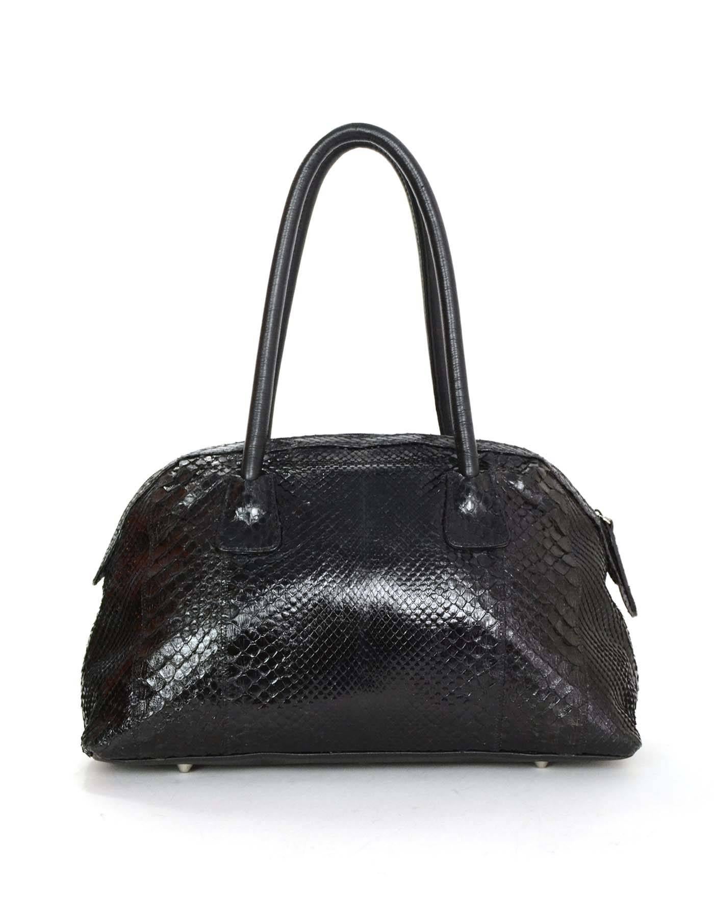 Features leather shoulder straps and zip top closure

    Color: Black
    Hardware: Silvertone
    Materials: Python and leather
    Lining: Multicolor printed textile
    Closure/Opening: Zip top
    Exterior Pockets: None
    Interior