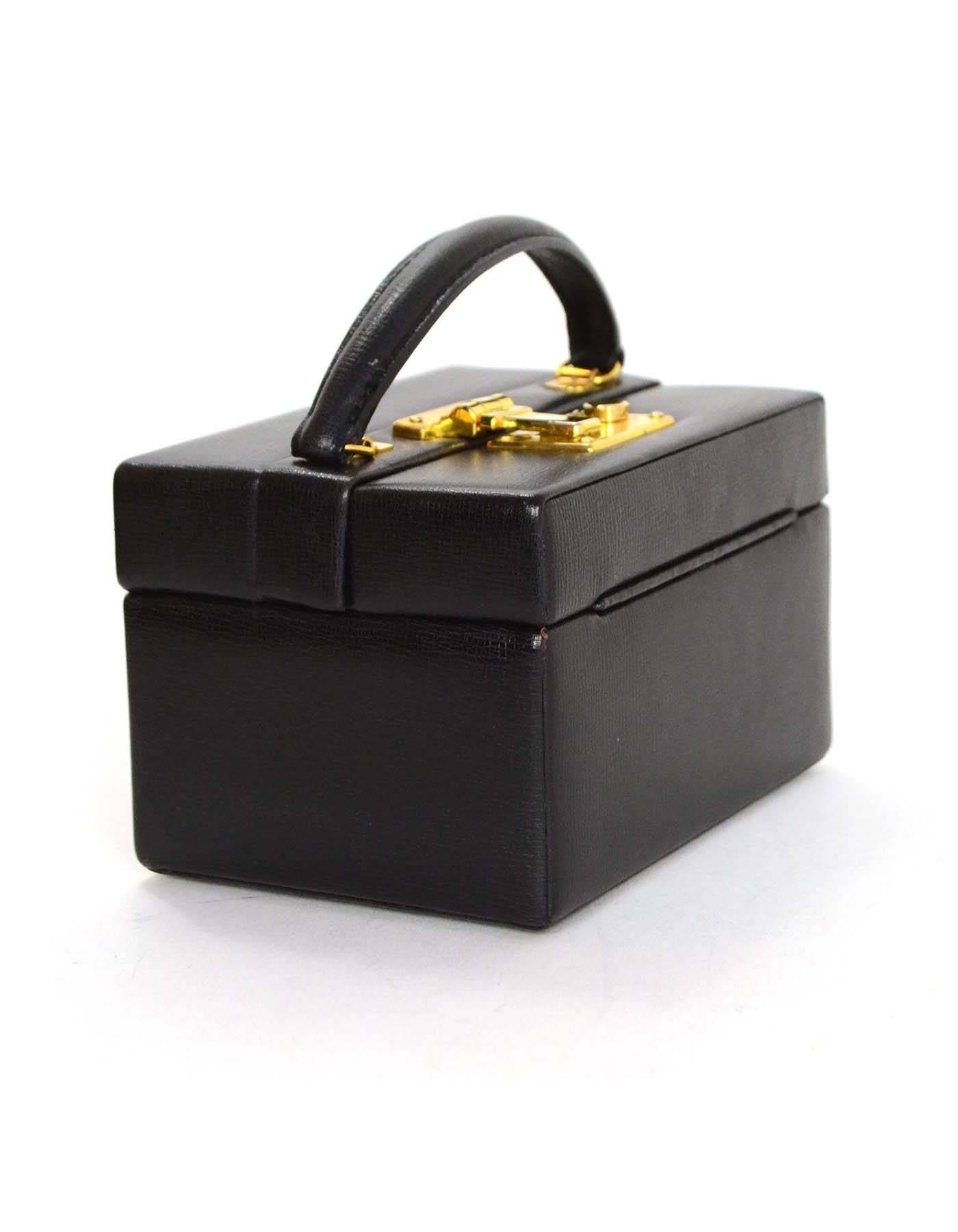 Mark Cross Black Mini Square Frame Bag with GHW

Made in: Italy
Year of Production: Vintage
Color: Black
Hardware: Goldtone
Materials: Leather
Lining: Black leather
Closure/opening: Push lock closure at top
Exterior Pockets: None
Interior
