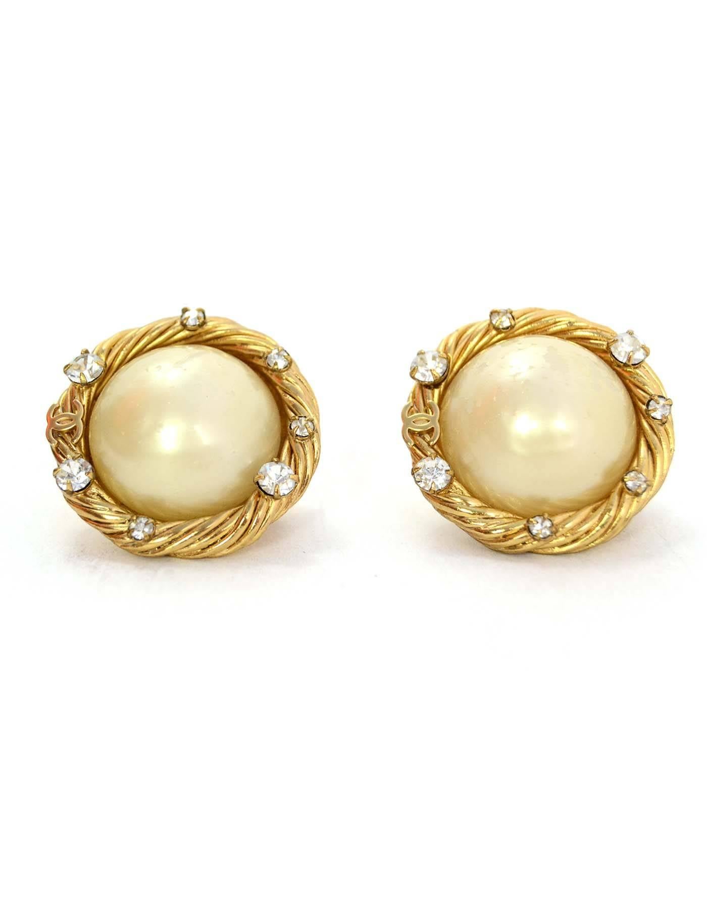 Chanel Goldtone, Pearl and Crystal Clip On Earrings 

Made In: France
Year of Production: 2001
Color: Goldtone and ivory
Materials: Faux pearl and metal
Closure: Clip on
Stamp: Chanel 01 CC P Made in France
Overall Condition: Very good