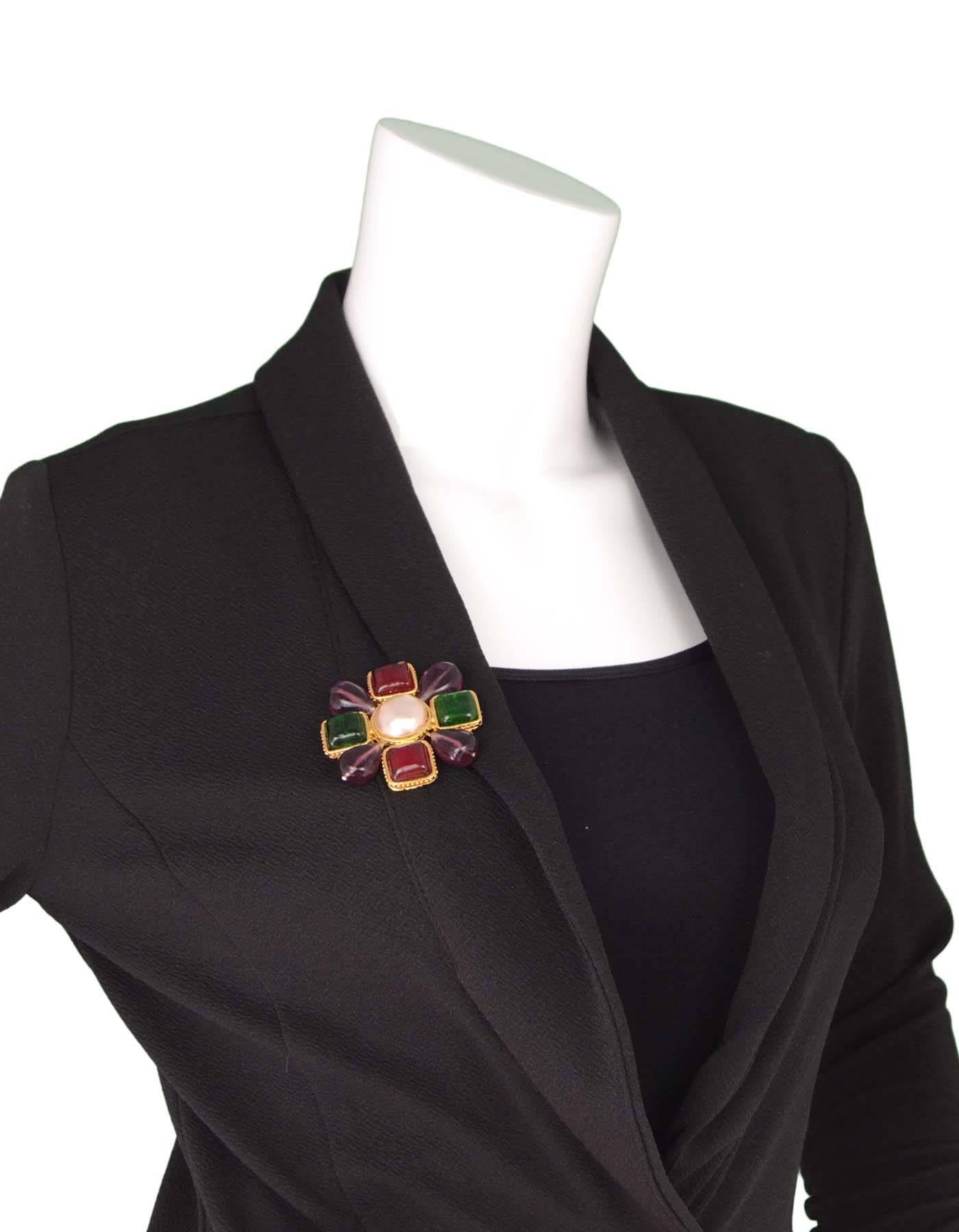 Chanel Multicolored Gripoix Brooch

Made In: France
Year Of Production: 1987
Color: Multicolored
Materials: Metal, gripoix, and faux jewels
Closure: Pin back closure
Stamp: Chanel 2 CC 5 Made in France
Overall Condition: Excellent pre-owned