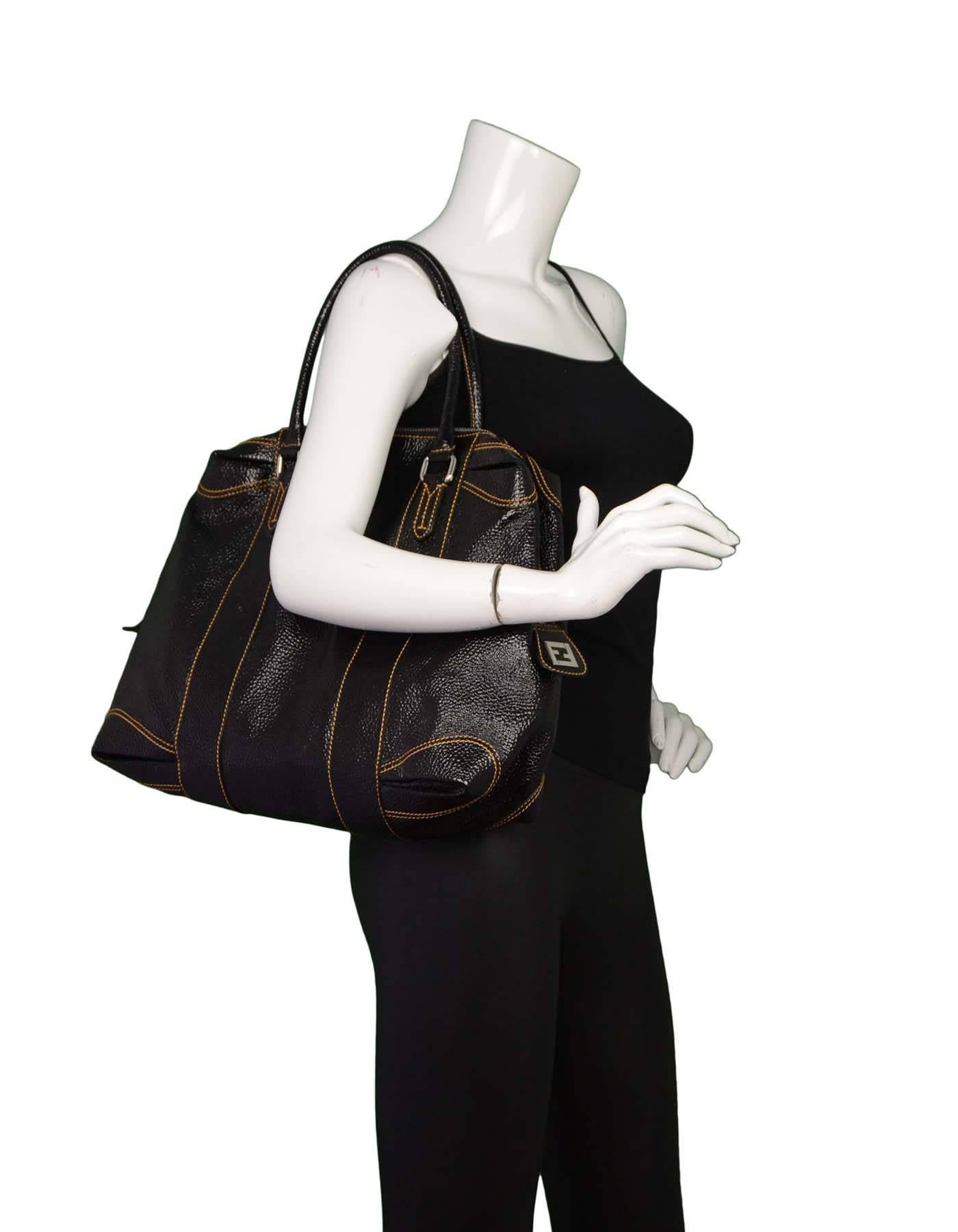 Fendi Black Grained Patent Leather Tote

Made in: Italy
Color: Black
Hardware: Silvertone
Materials: Patent leather
Lining: Black textile
Closure/opening: Zip top closure
Exterior Pockets: None
Interior Pockets: Two wall pockets
Overall
