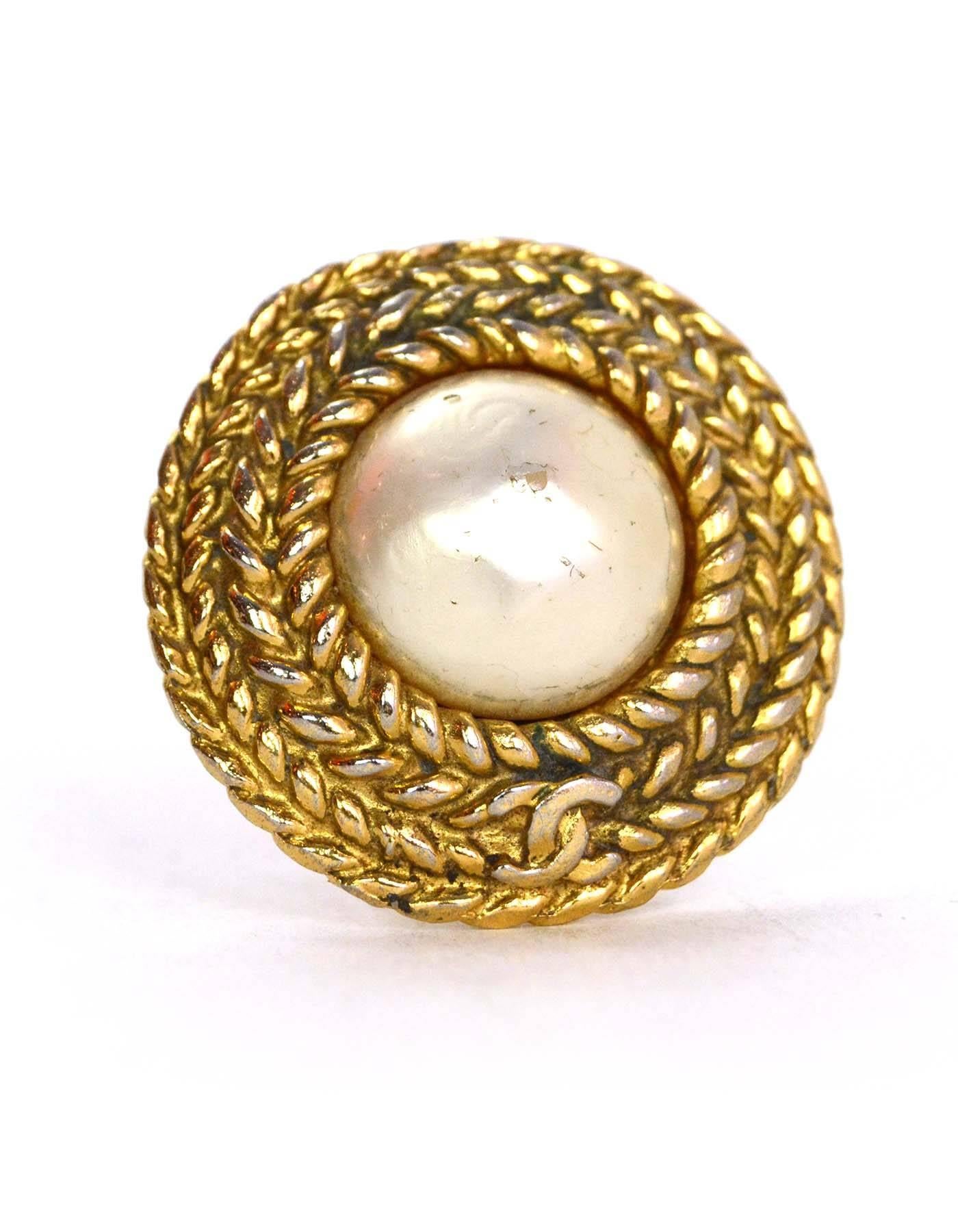 Chanel Goldtone and Pearl Clip-On Earrings

Made In: France
Year of Production: 1970-1980
Color: Goldtone and faux pearl
Materials: Faux pearl and metal
Closure: Clip on
Stamp: Chanel CC Made In France
Overall Condition: Very good vintage