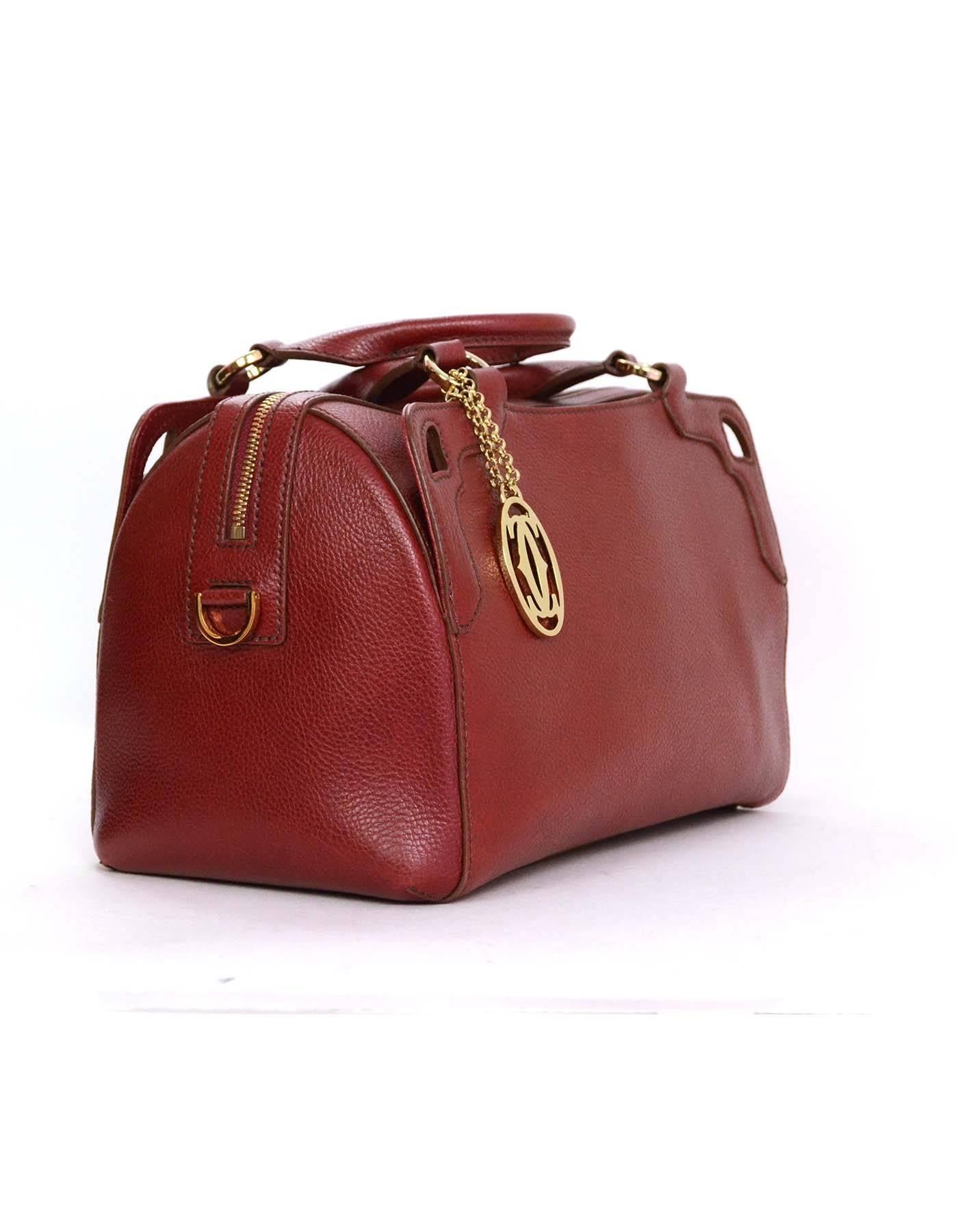 Cartier Bordeaux Doctor Bag

Features goldtone Cartier logo charm

    Made in: Italy
    Color: Bordeaux deep red
    Hardware: Goldtone
    Materials: Leather
    Lining: Beige textile
    Closure/opening: Zip top
    Exterior Pockets: