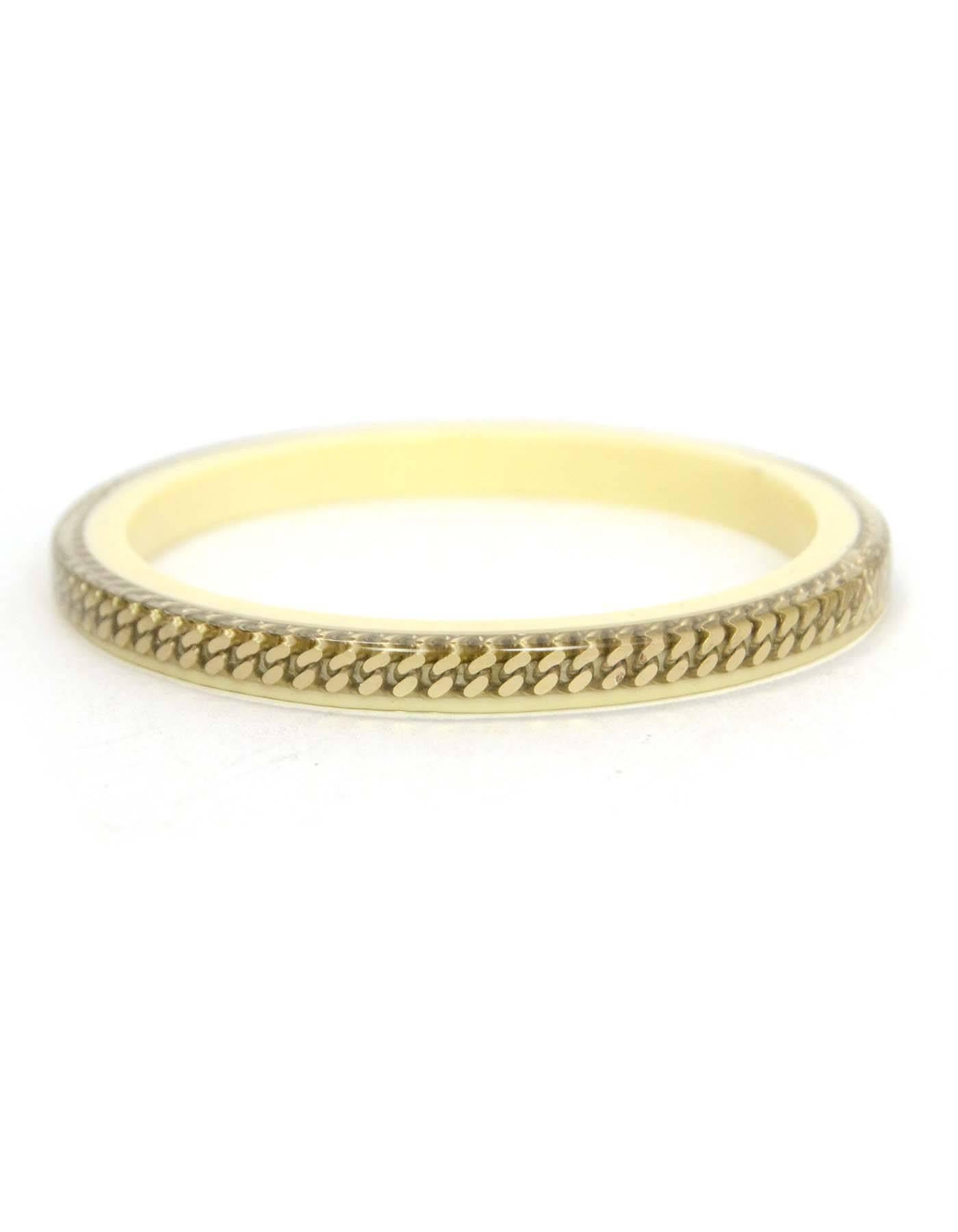 Chanel Ivory Resin & Chain Link Bangle
Features CC charms between chainlink inside of resin
Color: Ivory and goldtone
Materials: Resin and metal
Closure: None
Overall Condition: Excellent pre-owned condition with the exception of missing date