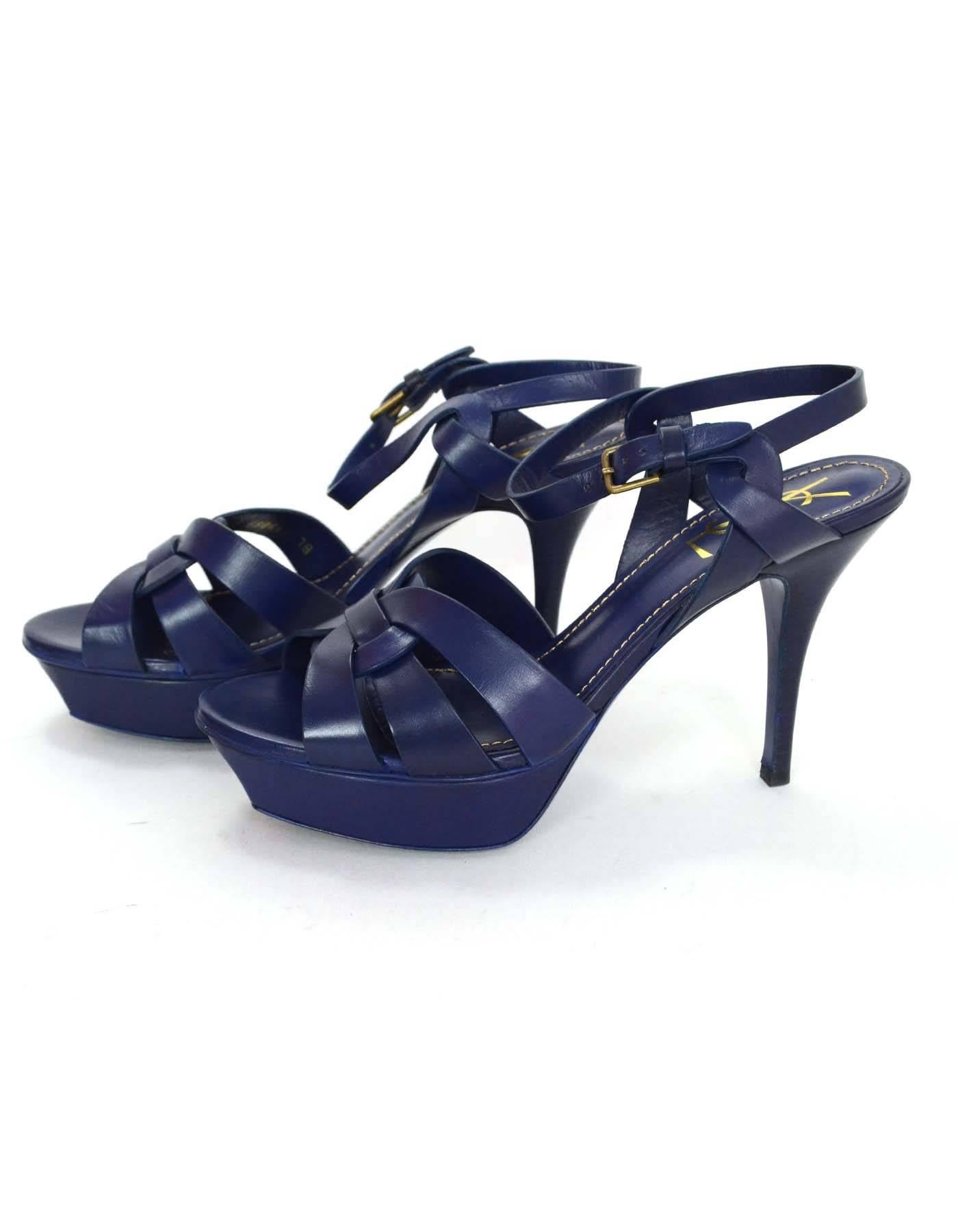 YSL Navy Leather Tribute 75 Strappy Sandals 
Made In: Italy
Color: Navy blue
Materials: Leather
Closure/Opening: Ankle buckle and notch closure
Sole Stamp: Yves Saint Laurent Made in Italy 38 1/2
Retail Price: $925 + tax
Overall Condition: