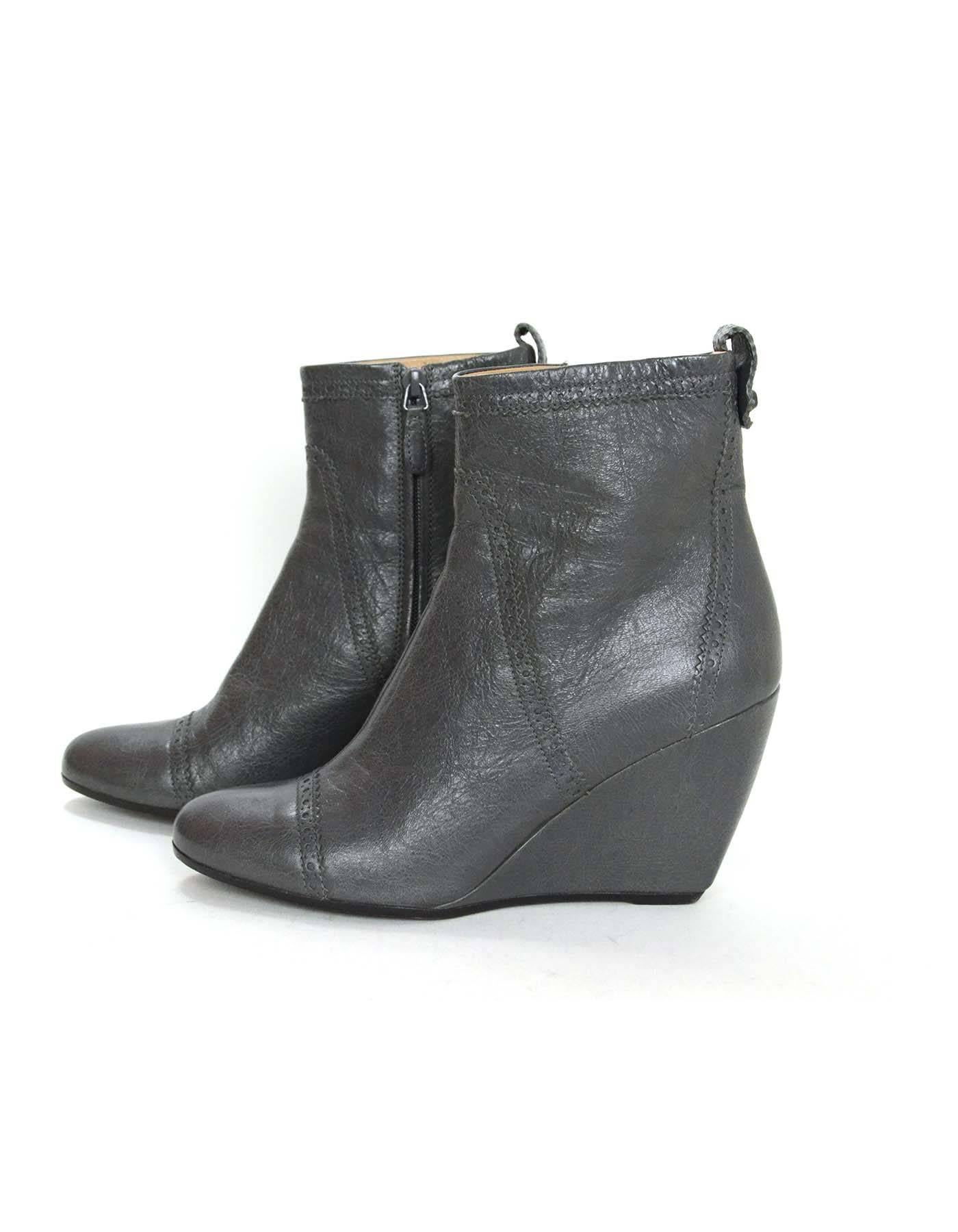 Balenciaga Grey Leather Brogue Ankle Boots 
Features spectator design at trim and back covered leather signature stud

Made In: Italy
Color: Grey
Materials: Leather
Closure: Size zip closure
Sole Stamp: Balenciaga 41 Made in Italy
Overall