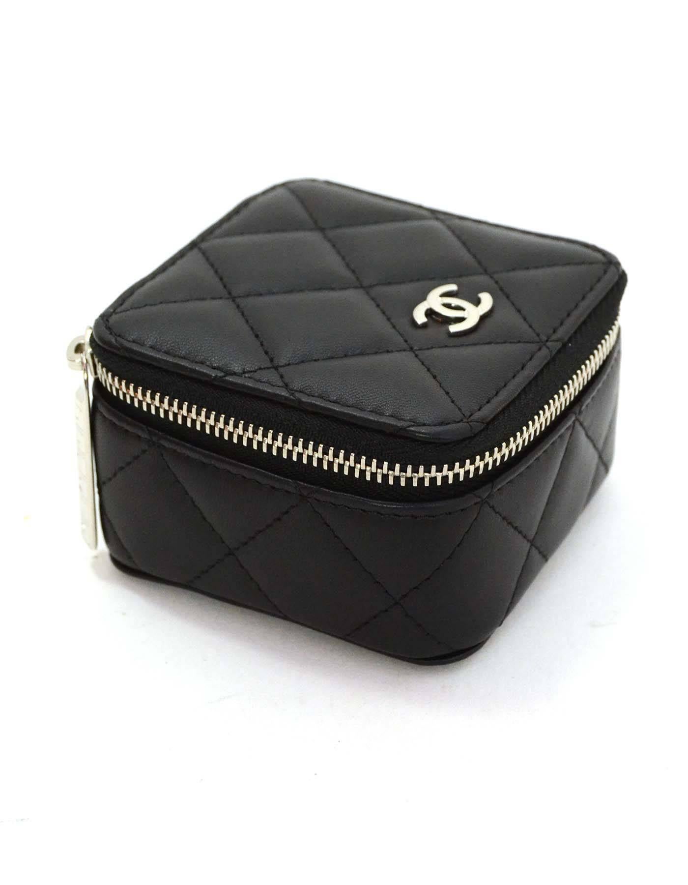 Chanel Black Quilted Leather Jewelry Box

Made In: Italy
Year of Production: 2016
Color: Black
Hardware: Silvertone
Materials: Leather
Lining: Burgundy suede
Closure/Opening: Zip flap top
Serial Number/Date Code: 22398138
Overall