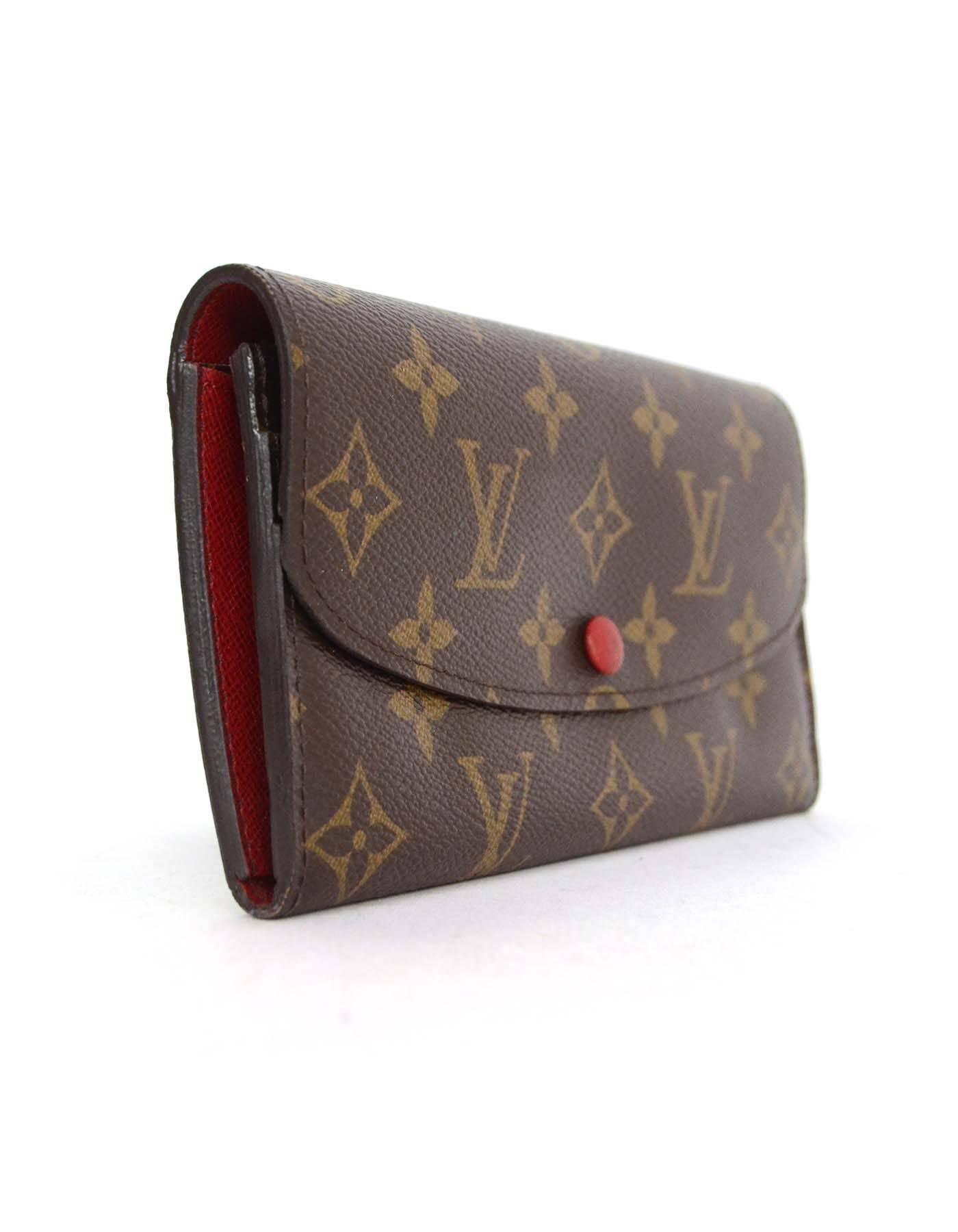 Louis Vuitton Brown and Red Monogram Emilie Wallet

Made In: Spain
Year of Production: 2013
Color: Brown and red
Hardware: Goldtone
Materials: Coated canvas
Lining: Coated canvas
Closure/Opening: Flap top with snap closure
Exterior Pockets:
