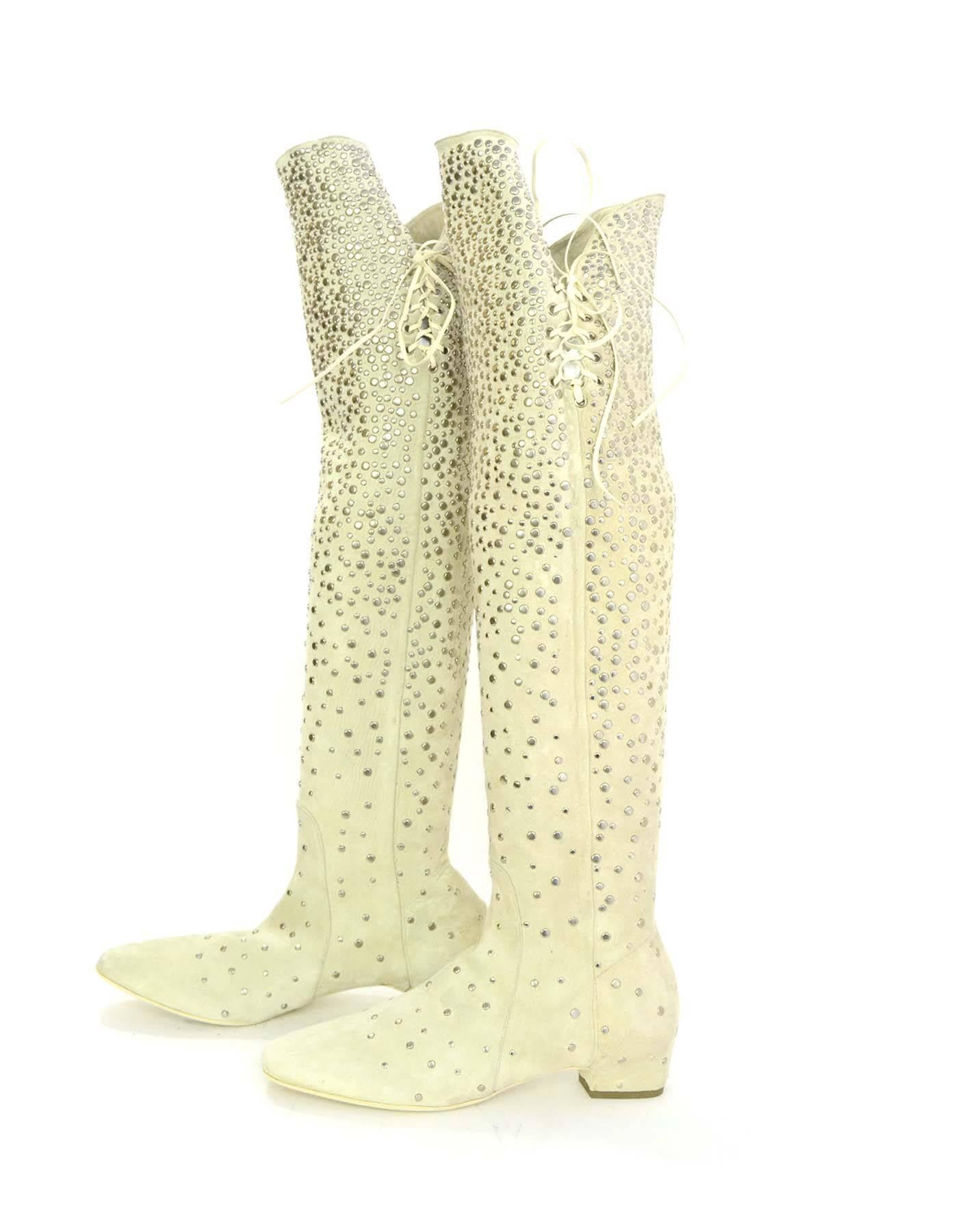 Salvatore Ferragamo Cream Suede Studded Boots Sz 37
Features lace tie at sides and silvertone studding throughout

Made In: Italy
Color: Cream
Materials: Suede
Closure/Opening: Pull on with tie closure at sides
Sole Stamp: Salvatore Ferragamo