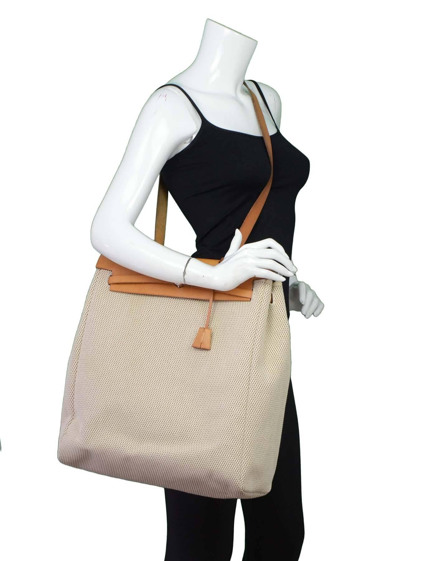Hermes Tan and Beige Toile Two-in-One Herbag

Made in: France
Year of Production: 2001
Color: Tan and beige
Hardware: Palladium
Materials: Leather and canvas
Lining: None
Closure/opening: Flap top with pull closure
Exterior Pockets: