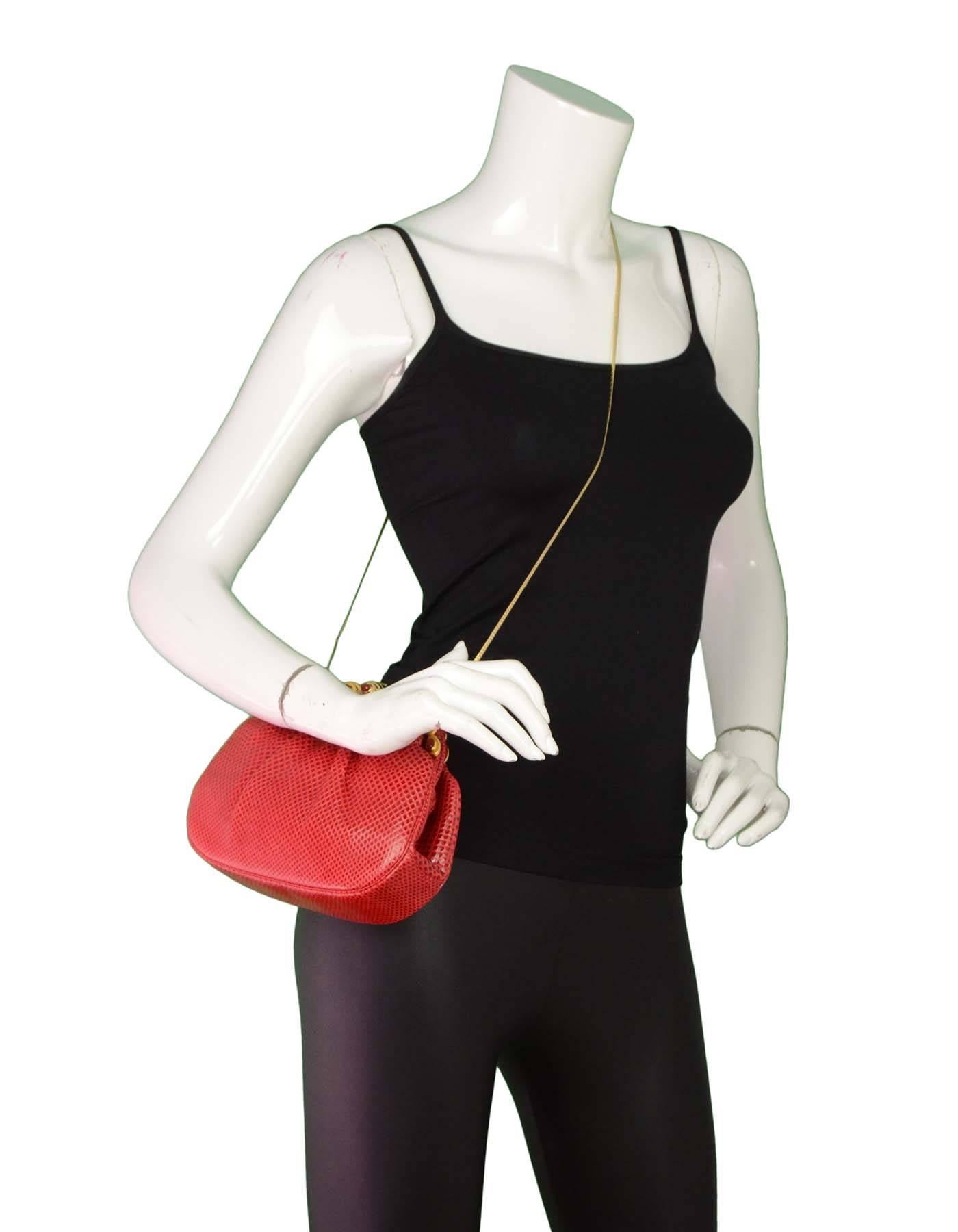 Judith Leiber Red Karung Clutch with GHW

Features optional shoulder strap that can be tucked into bag

Color: Red
Hardware: Goldtone
Materials: Karung snakeskin and metal
Lining: Red textile
Closure/Opening: Frame top with jeweled snap lock