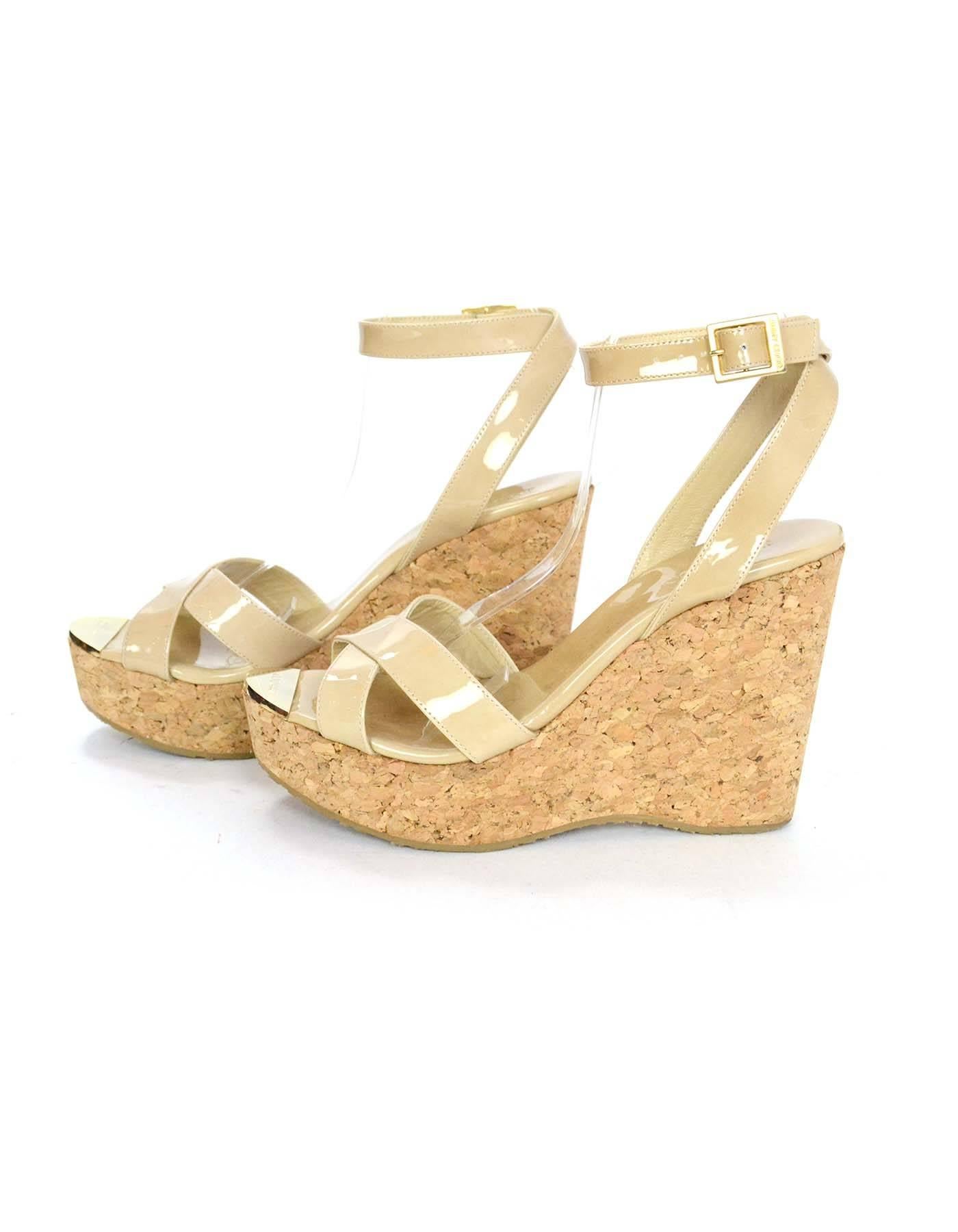 Jimmy Choo Patent Leather Nude and Cork Wedges Sz 39

Made In: Spain
Color: Nude
Materials: Patent leather
Closure/Opening: Ankle strap with buckle closure
Sole Stamp: Jimmy Choo Made in Spain 39
Overall Condition: Excellent pre-owned