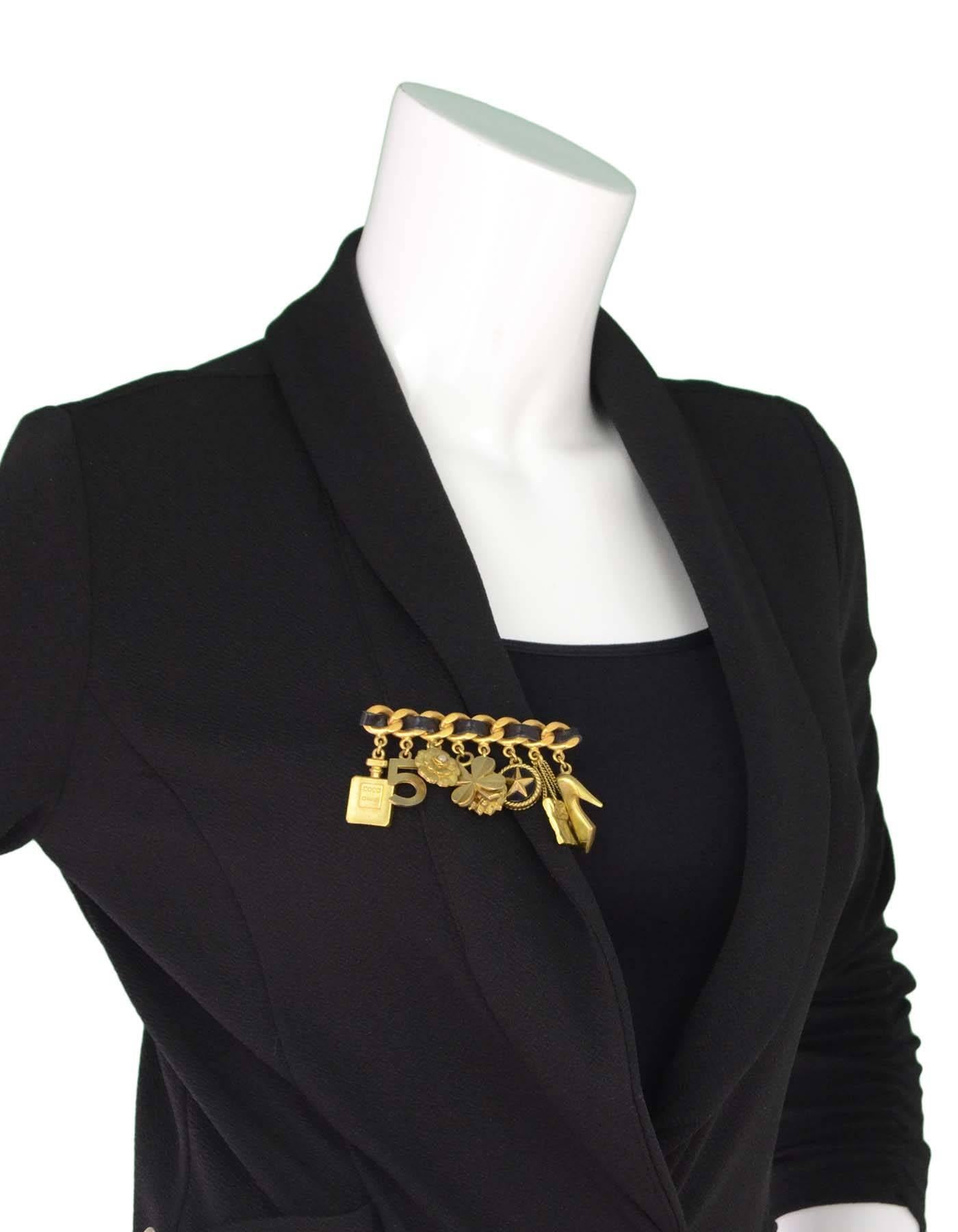 Chanel Leather and Charm Brooch

Made In: France
Year Of Production: 1994
Color: Goldtone and black
Materials: Metal and leather
Closure: Pin back closure
Stamp: Chanel 94 CC P MAde in France
Overall Condition: Very good vintage pre-owned