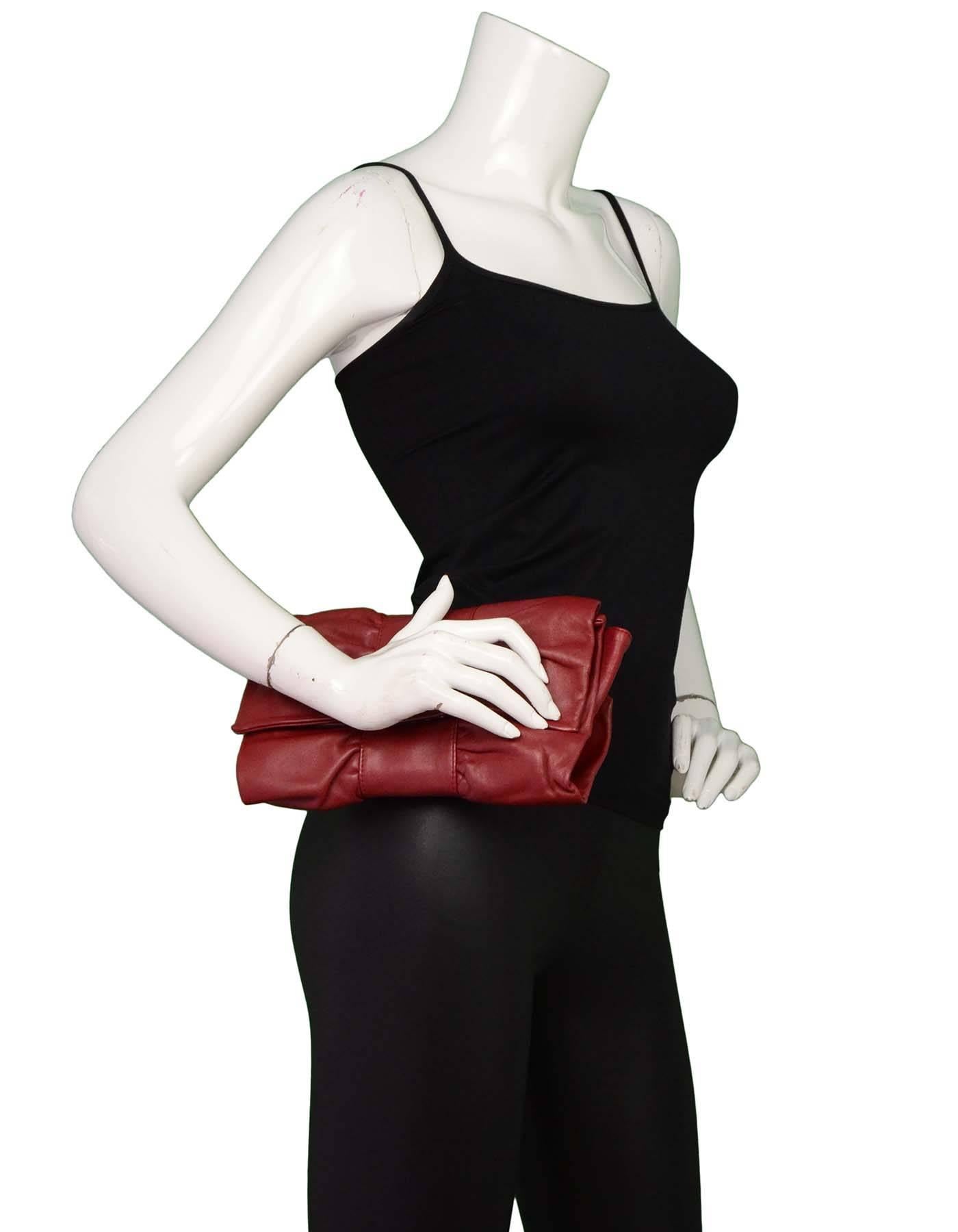 Furla Burgundy Leather Bow Clutch

Made In: Italy
Color: Burgundy
Hardware: None
Materials: Leather
Lining: Black and white polka dot textile
Closure/Opening: Flap top with magnetic closure
Exterior Pockets: None
Interior Pockets: One wall